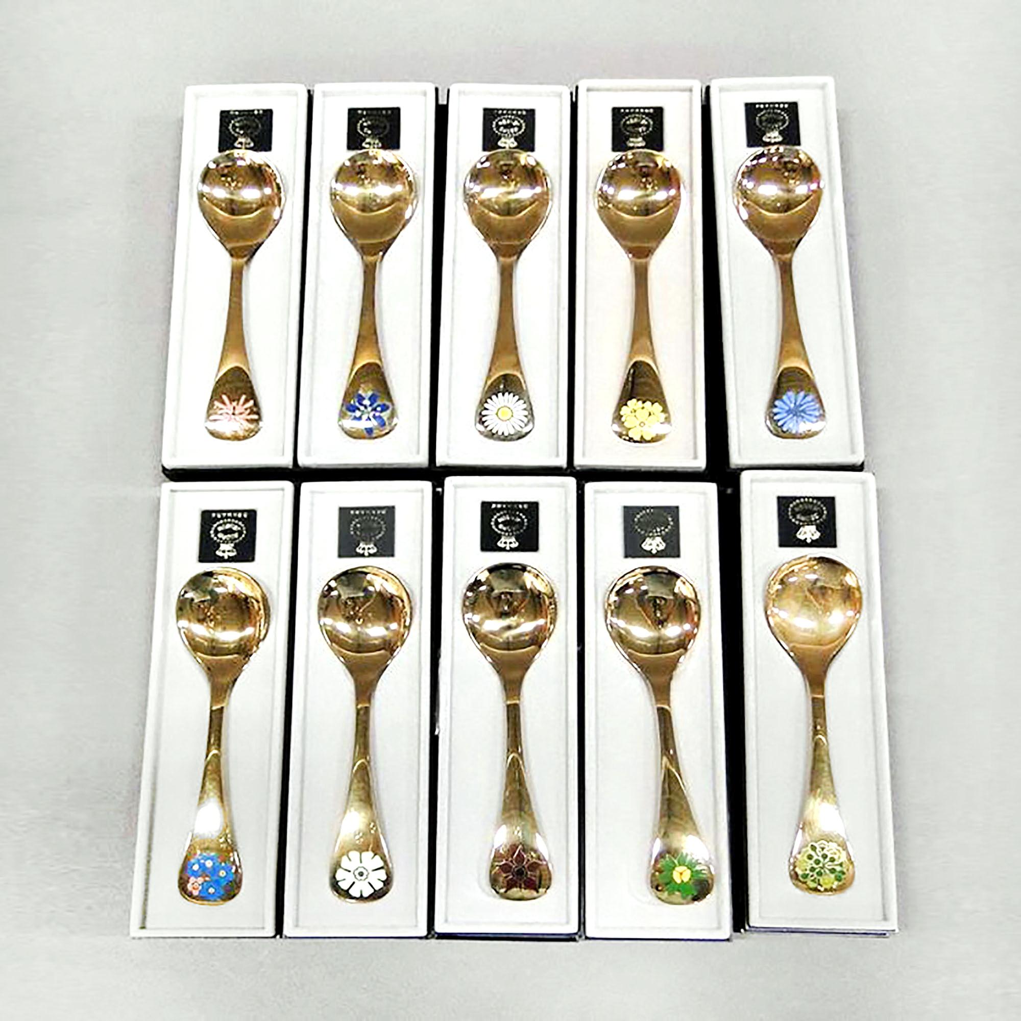 Annual spoons 1980-1989 in original box, designed by Annelise Björner, edited by Georg Jensen.
Annual spoons series began in 1971. Each spoon is crafted in sterling silver, then gold-plated and enameled with a wildflower chosen for that year. Year