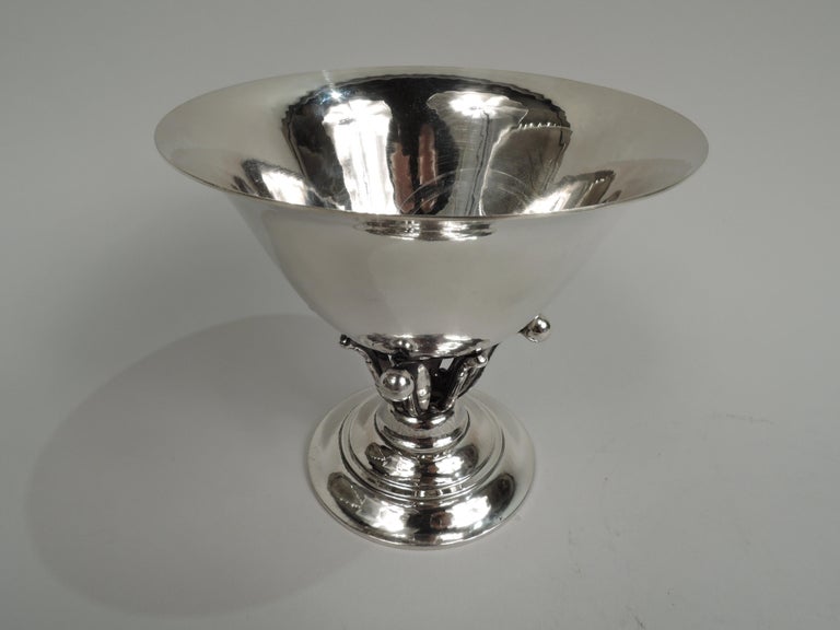 Art Nouveau sterling silver bowl. Made by Georg Jensen in Copenhagen. Round and tapering with flared rim set in open tendril support on round and stepped foot. Visible hand hammering. This design illustrated in: Drucker, Georg Jensen, 1997, p. 213.