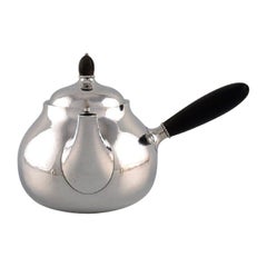 Tetera Art Nouveau Georg Jensen de plata de ley con eje y pomo de ébano