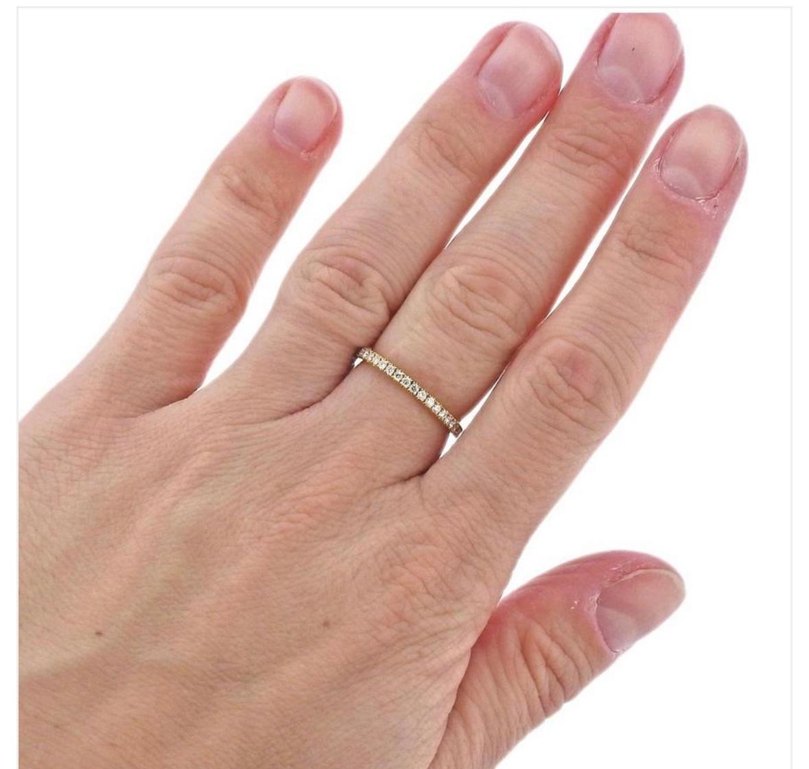 Indulge in a classic diamond wedding engagement stacking band ring by Georg Jensen.  The Aurora Diamond Band Ring in 18 Karat Yellow Gold is a size 6.5 US or 53 European Size.  
This single row of brilliant cut diamonds set into a minimal ring of 18