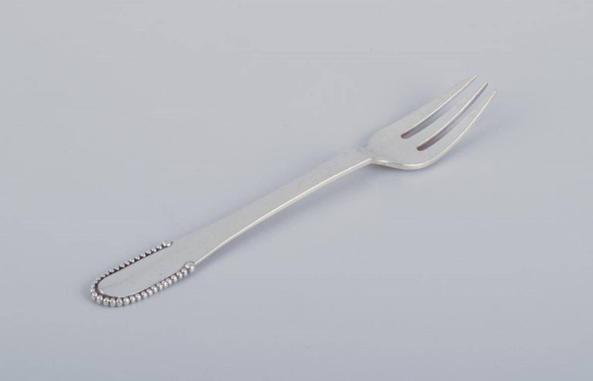 Danish Georg Jensen Beaded, nine cake forks in sterling silver. Hallmark: 1933–1944. For Sale