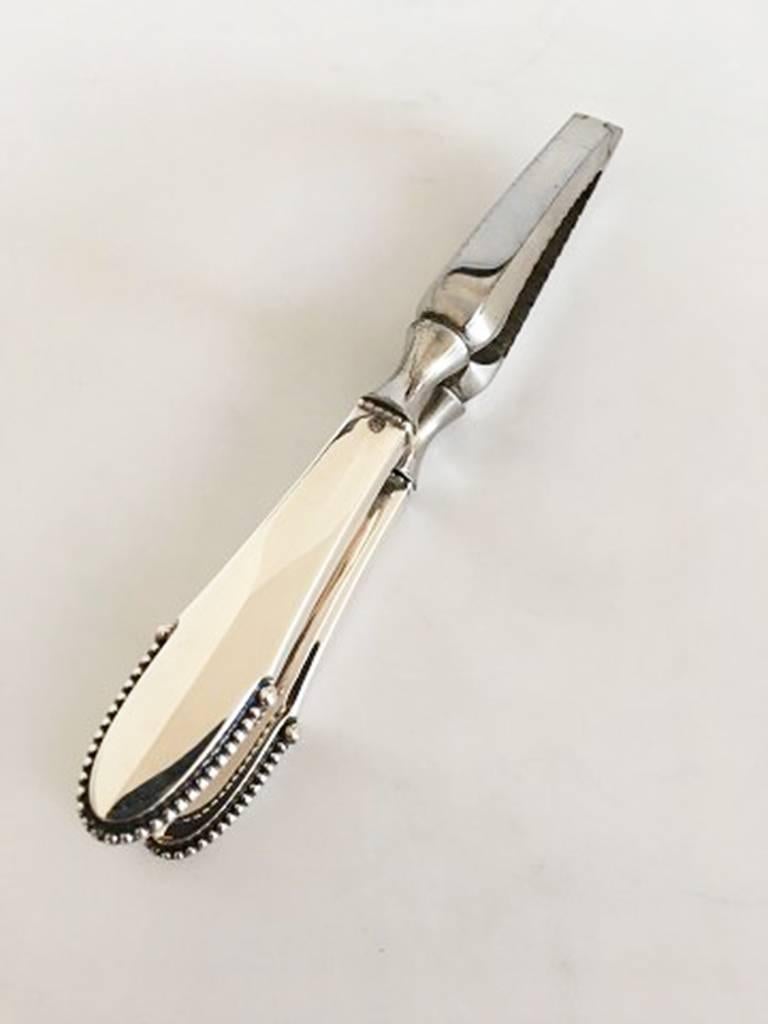 Georg Jensen beaded nutcracker/lobster cracker #255 in silver and steel. Measures 15 cm / 5 29/32 in.
