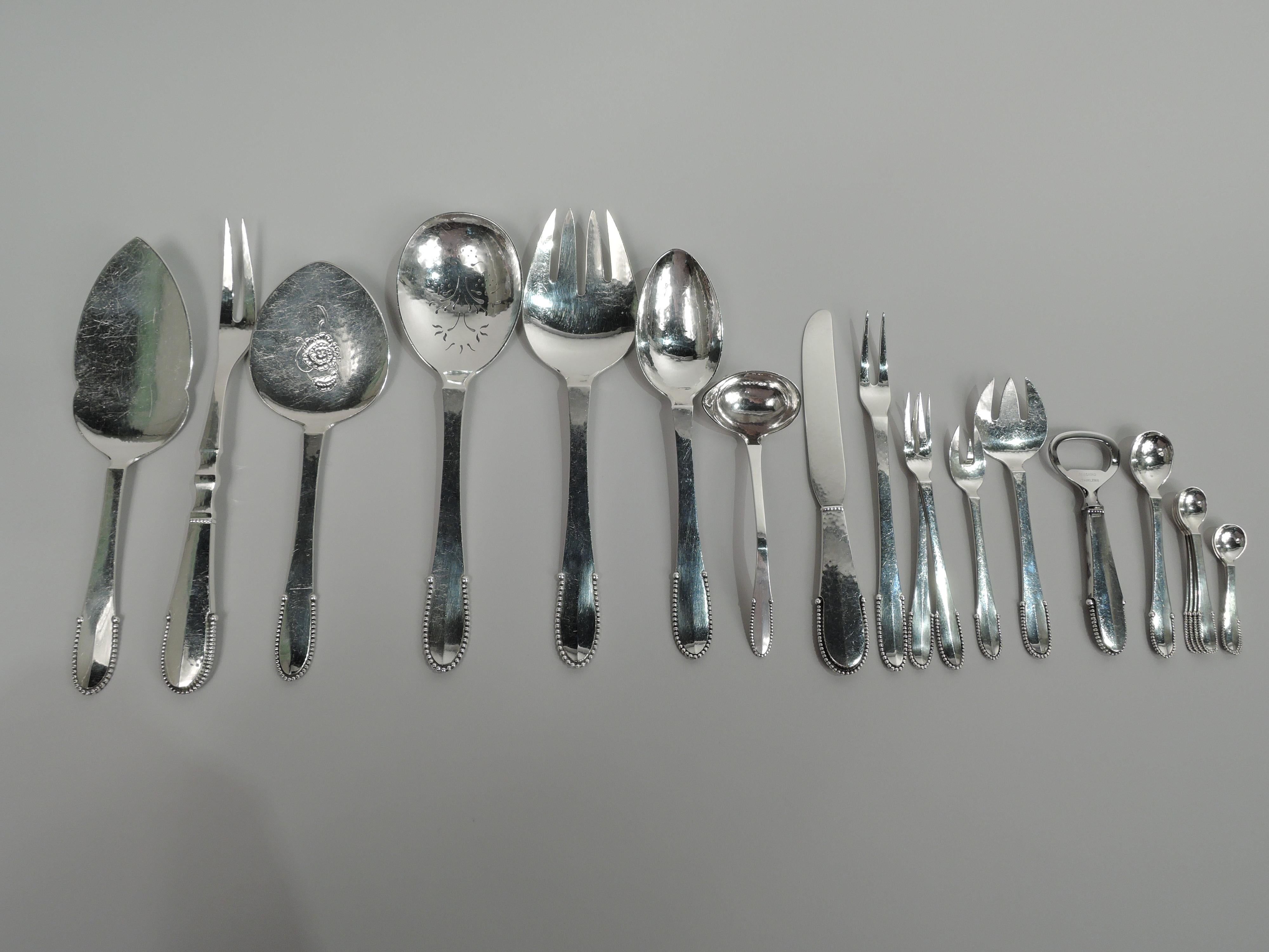 Beaded sterling silver dinner and lunch set. Made by Georg Jensen in Copenhagen.

This set comprises 157 pieces (dimensions in inches): Forks: 12 Dinner forks (7 1/4), 12 luncheon forks (6 7/8), 24 salad forks (6 3/4), 12 pastry forks (5 5/8), 2