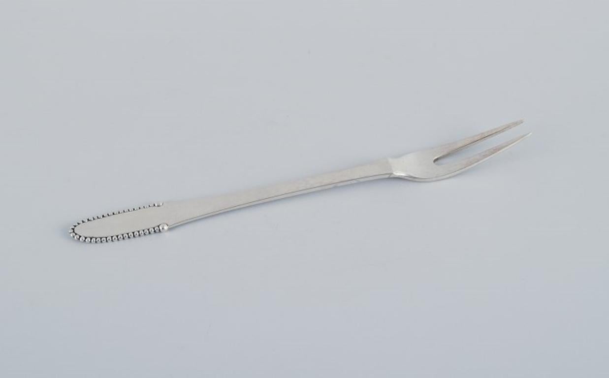 Georg Jensen Beaded.
Two meat forks in 830 silver.
1915-1930 hallmark.
In excellent condition.
Dimensions: L 18.2 cm.