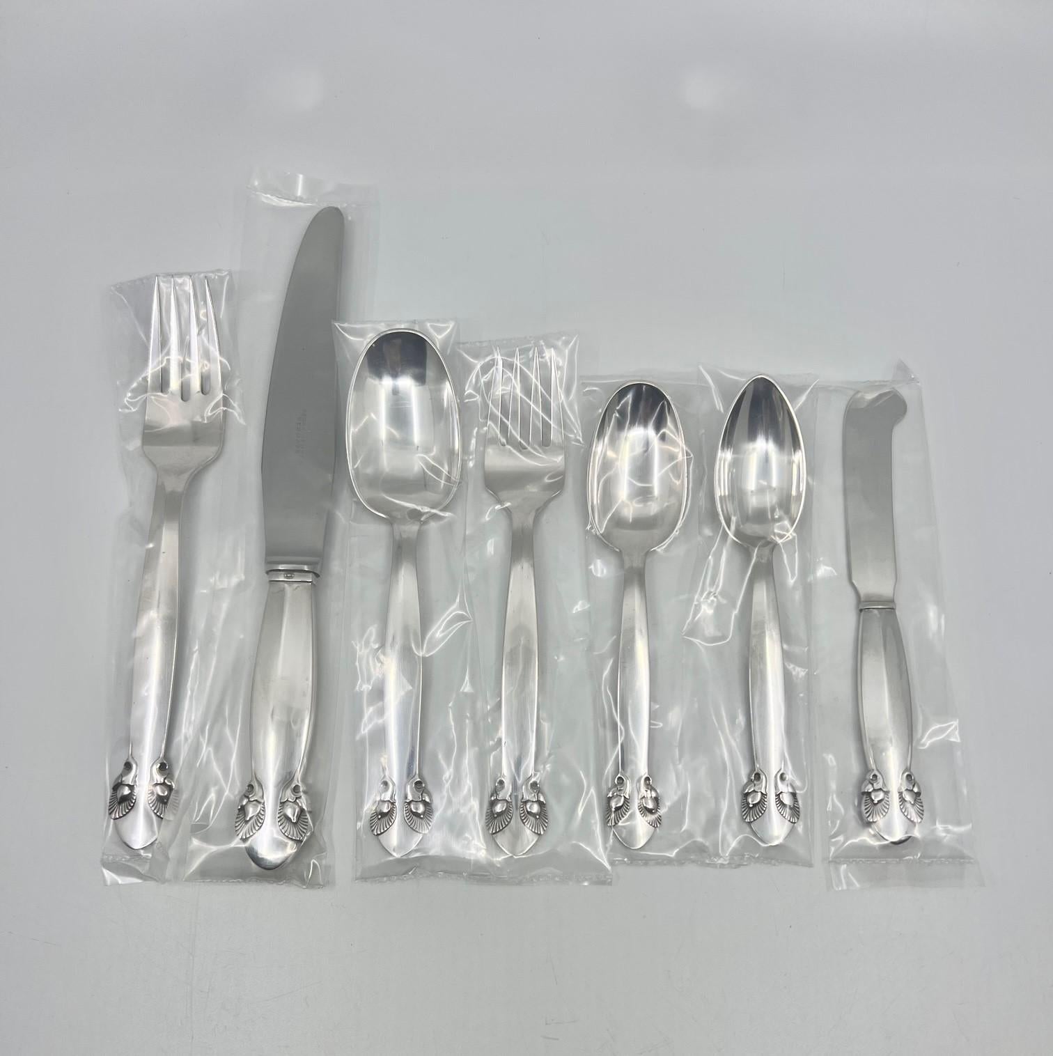 A vintage Georg Jensen sterling silverware service in the rare Bittersweet pattern, design #79 from 1940 by Gundorph Albertus. This is the sister pattern to Cactus, also designed by Gundorph Albertus. This estate set was all bought at Georg Jensen