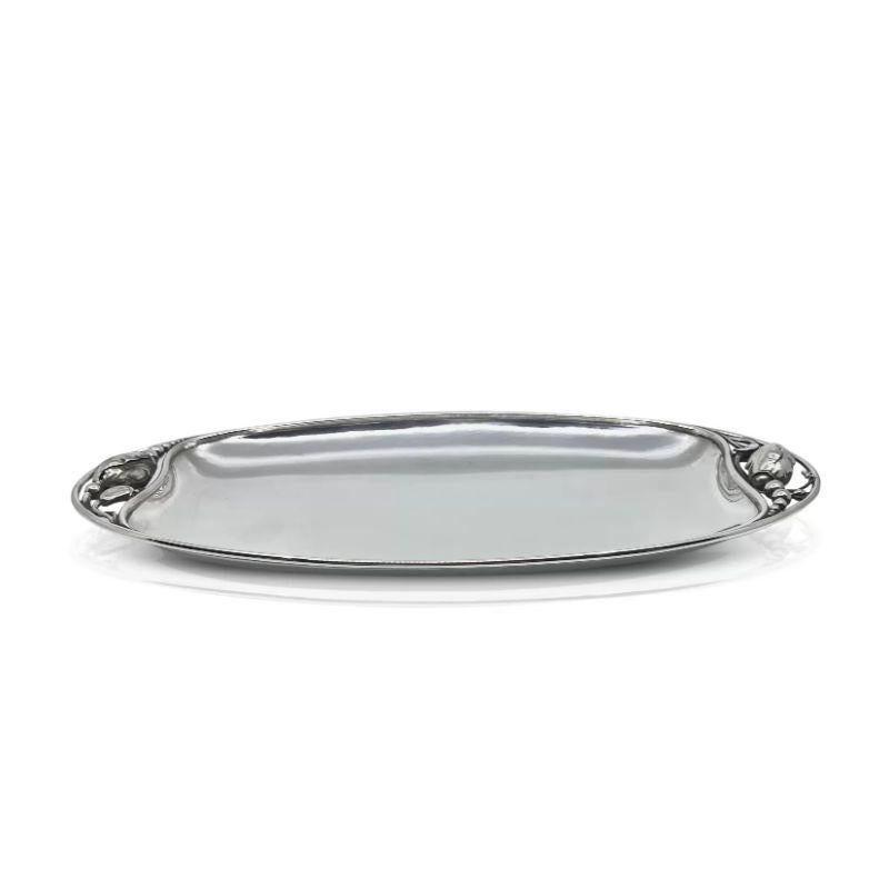 This exquisite sterling silver bread tray showcases the timeless beauty of Georg Jensen’s art nouveau Blossom/Magnolia pattern. Created in 1905, this design, designated as #2D, epitomizes the elegance and grace of the era. Crafted with meticulous