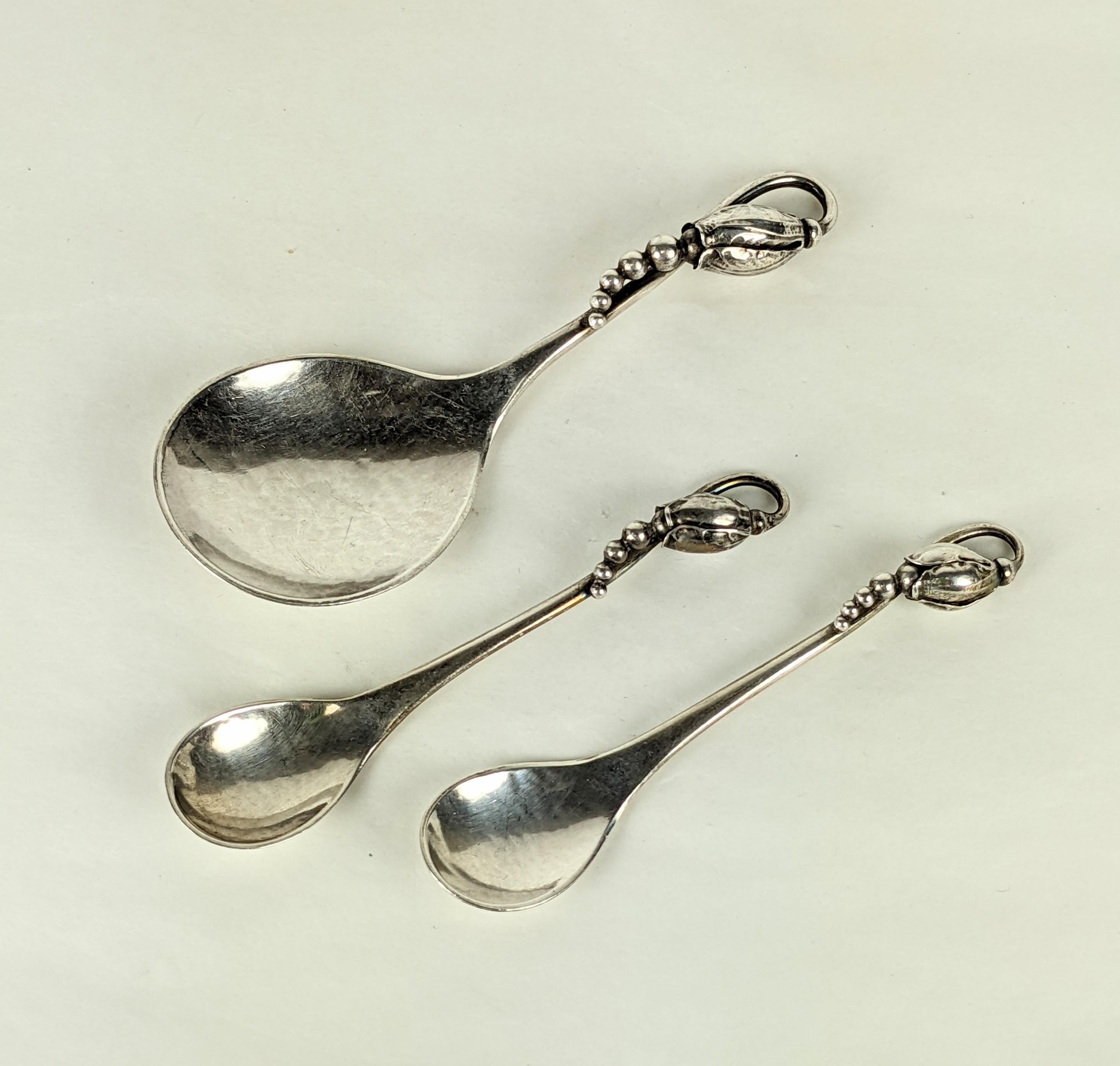 Set of 3 Georg Jensen handmade sterling serving pieces with early hallmarks in the Blossom pattern. A pair of master salt spoons and candy server. 1940's Denmark. 
3 pieces total. Smaller 3.5