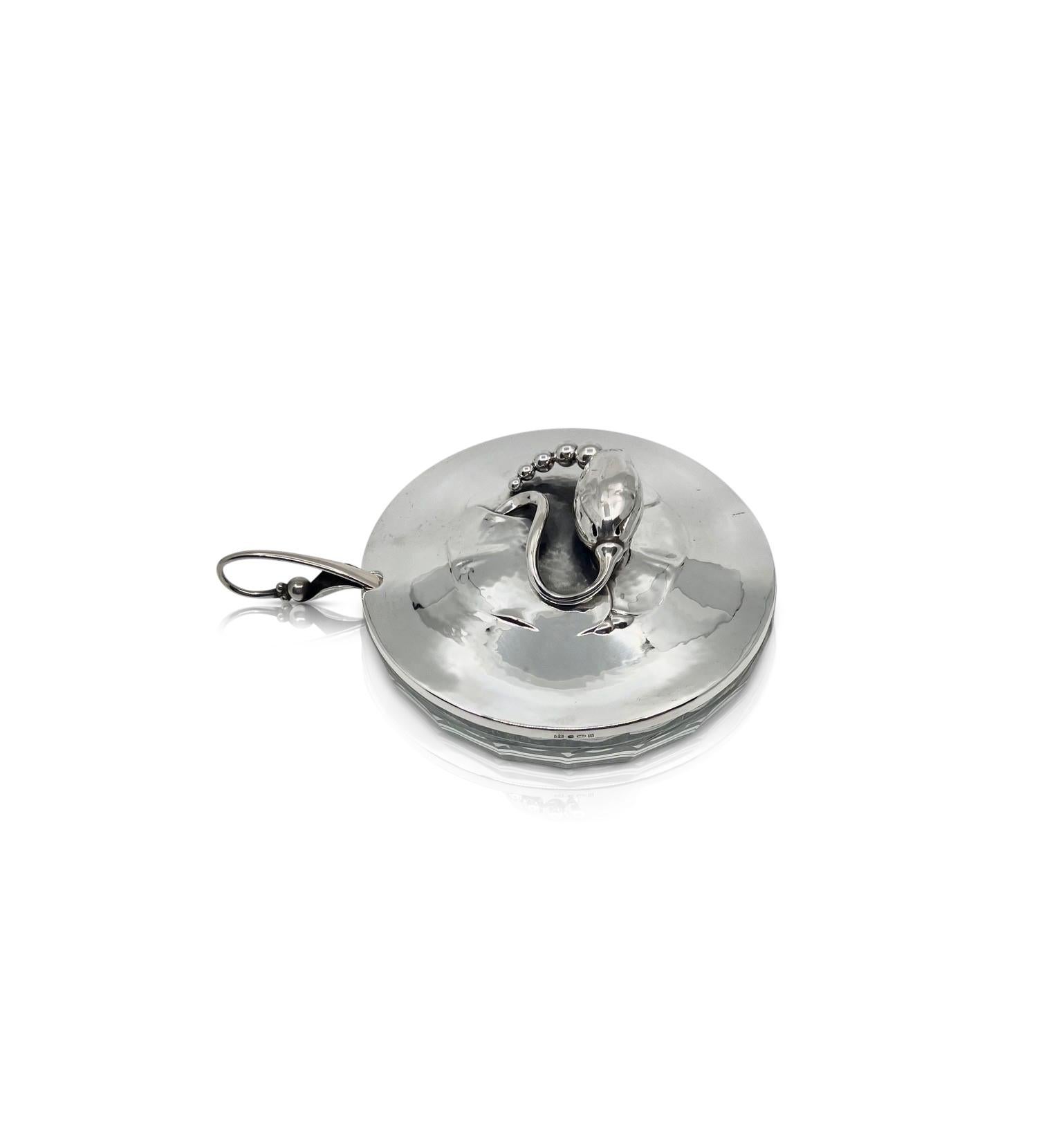 A Georg Jensen Blossom “Magnolia” sterling silver lidded Marmalade jar #2, designed by Georg Jensen circa 1905, is a beautiful example of the iconic art nouveau design. The marmalade jar features a sterling silver lid with a large Blossom floral