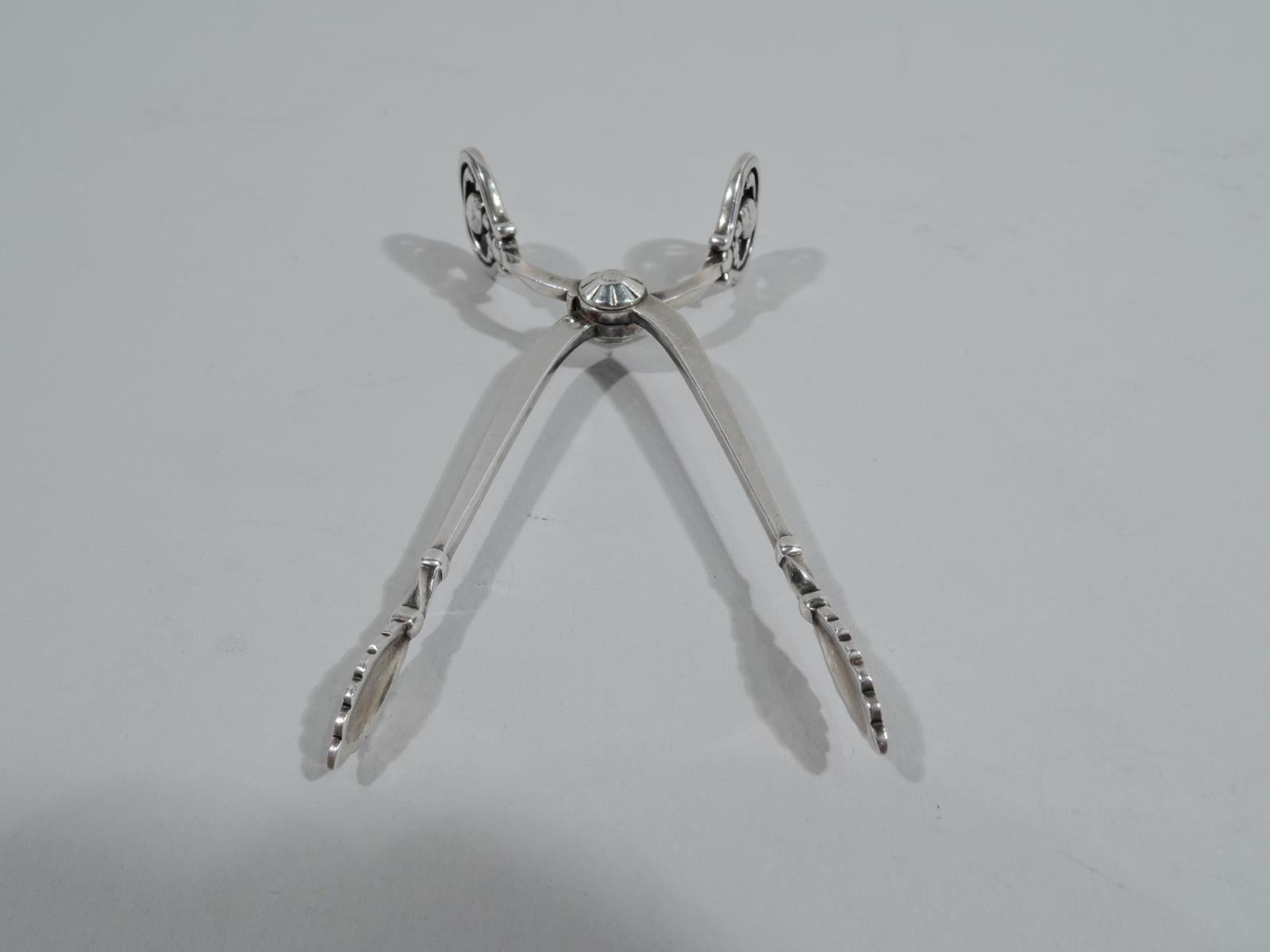 Blossom sterling silver sugar nips. Made by Georg Jensen in Copenhagen. Serrated leaf jaws and open terminals inset with seed-spilling pods. A great piece in the classic pattern. Fully marked with postwar maker's stamp.