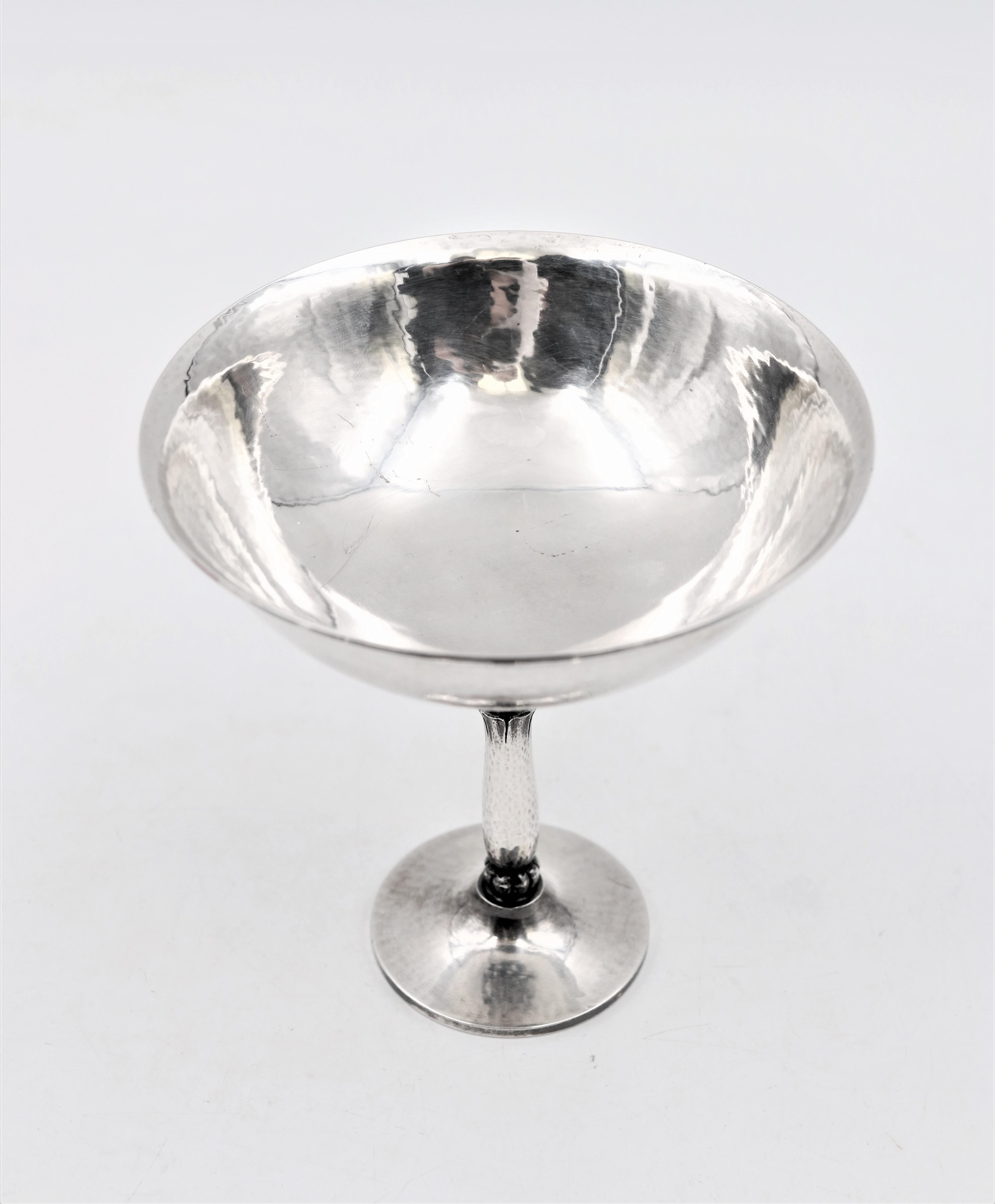 Georg Jensen hand hammered sterling silver berry server in pattern 479B, designed by Harald Nielsen with exquisite decorations on the stem from the mid to late 20th century. Measuring 4 2/3'' in height by 4 1/3'' in diameter and weighing 7.1 ozt.