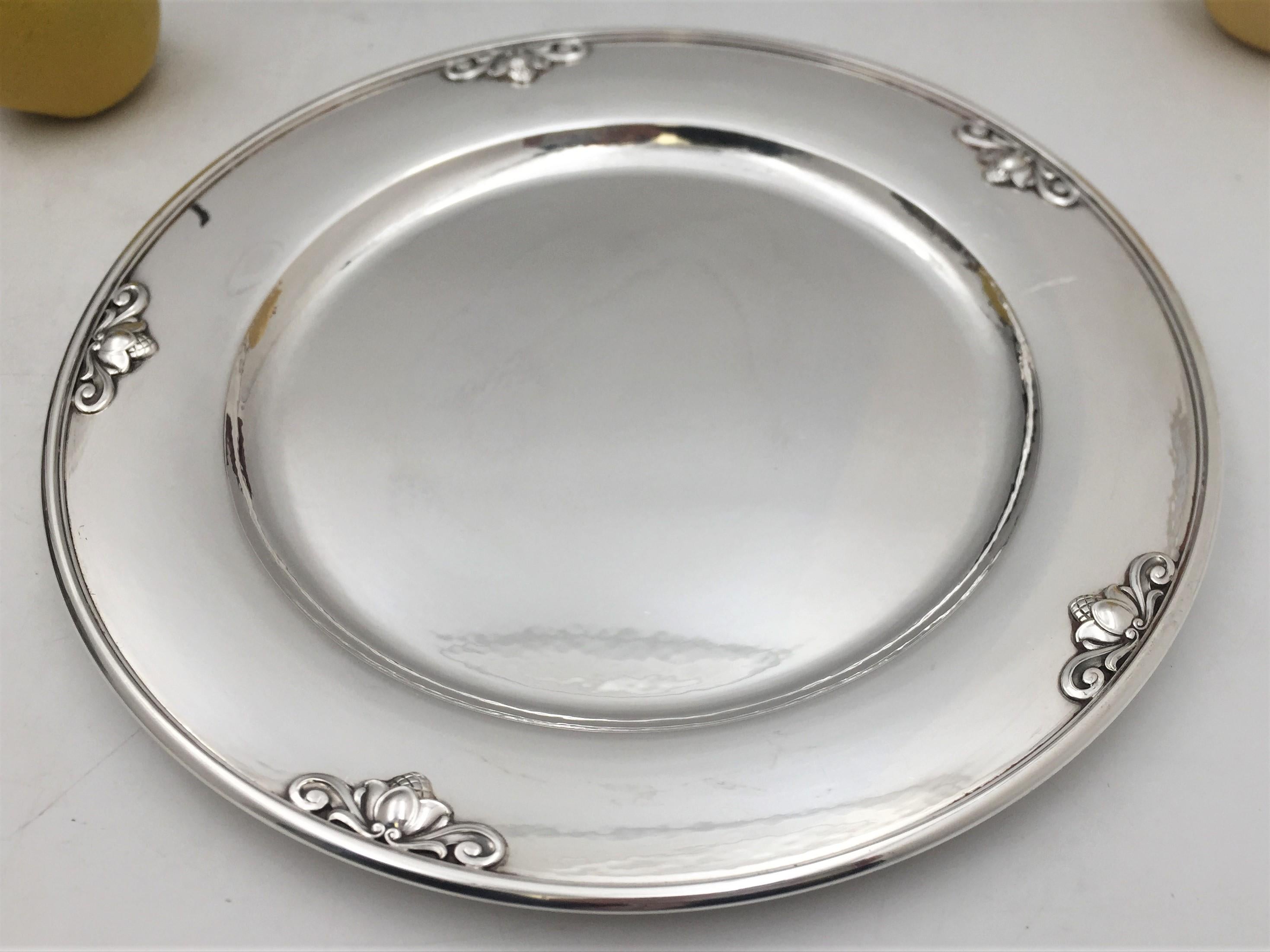 Georg Jensen by J. Rohde sterling silver charger/ dinner plate in celebrated Acorn pattern number 642A. It measures 11'' in diameter by 3/4'', weighs 22.2 troy ounces, and bears hallmarks as shown. 

Johan Rohde hailed from a wealthy family and