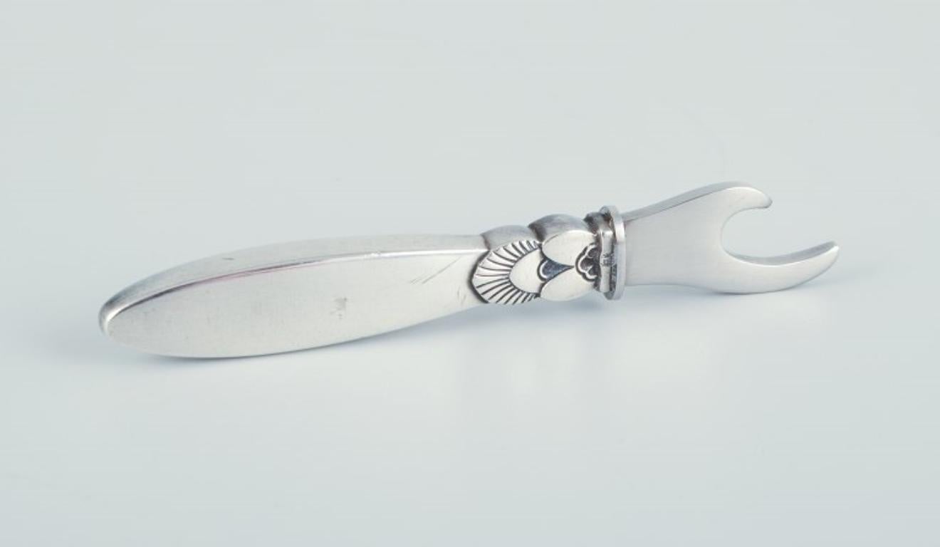 Art Deco Georg Jensen Cactus. Bottle opener in sterling silver and stainless steel. For Sale