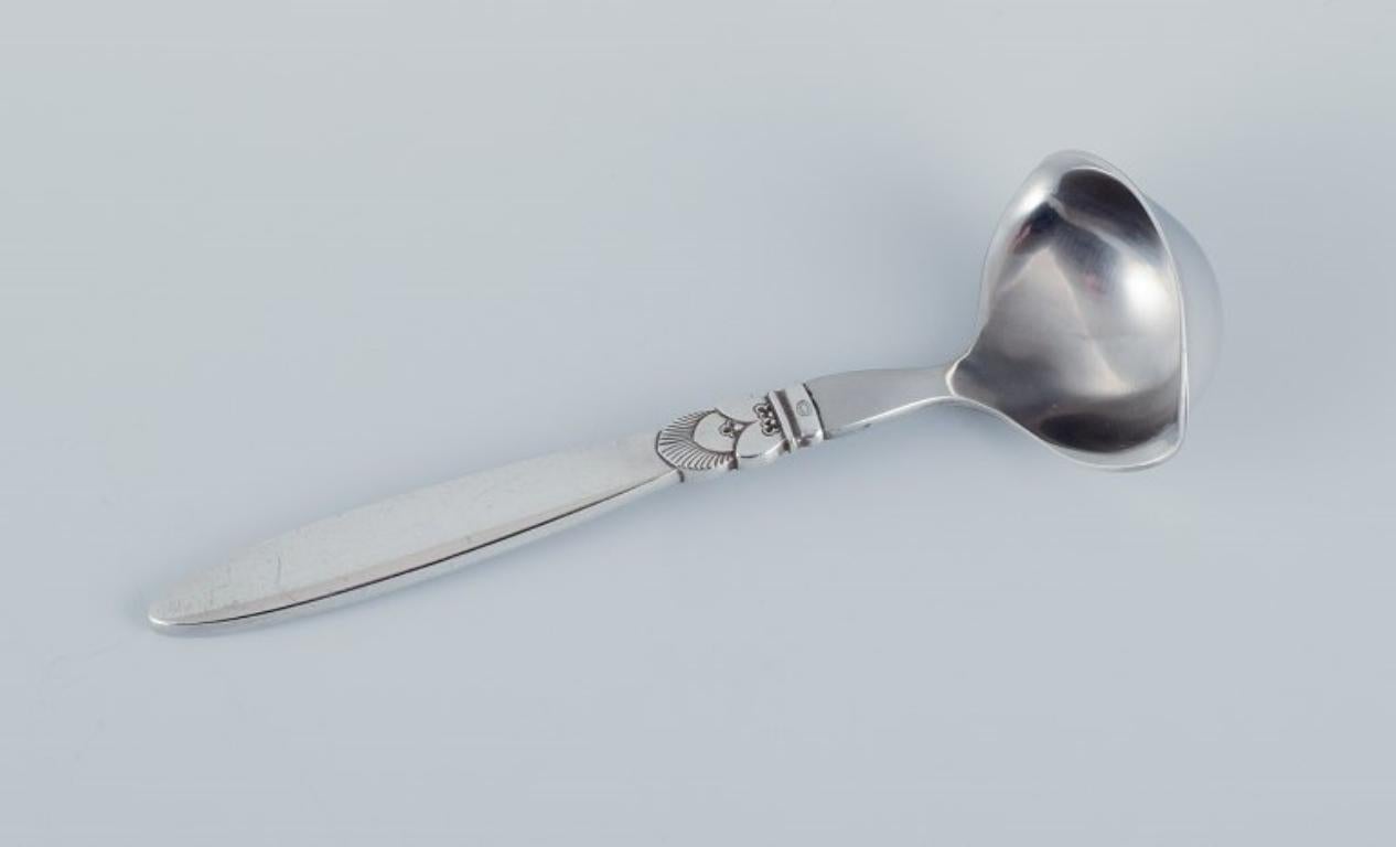 Georg Jensen, Cactus, a sterling silver and stainless steel sauce spoon.
Stamped with the hallmark after 1944.
In excellent condition.
Dimensions: L 20.0 cm.