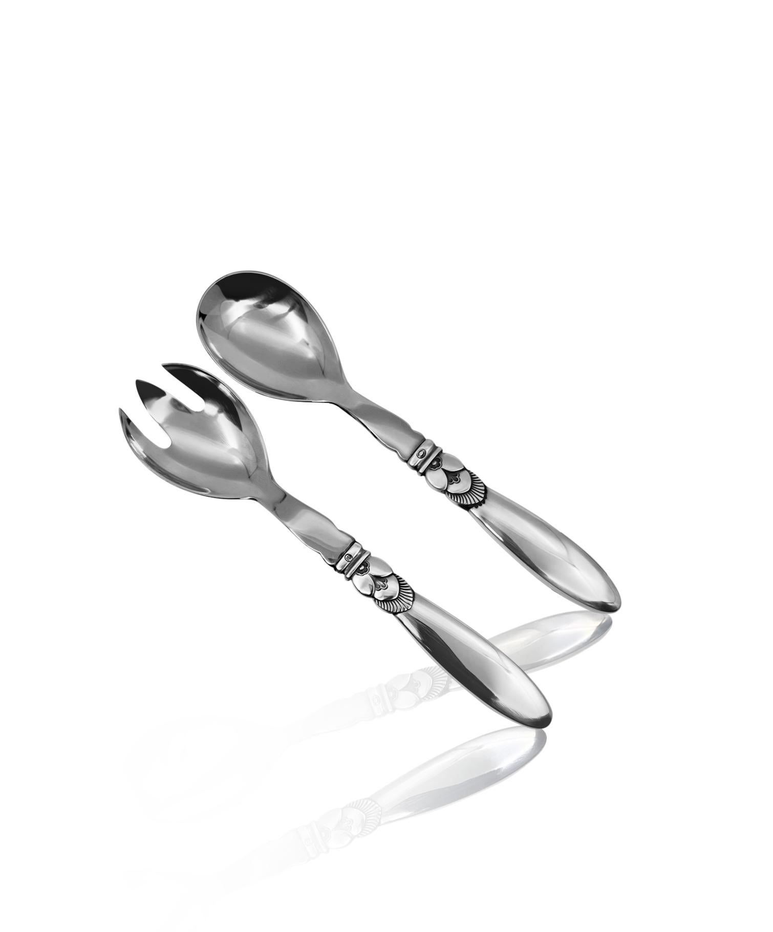 Sterling silver and stainless steel Georg Jensen small salad set, set 134 in the Cactus pattern, design #30 by Gundorph Albertus from 1930.

Additional information:
Material: Sterling Silver
Style: Art Deco
Hallmarks: With Georg Jensen hallmark,