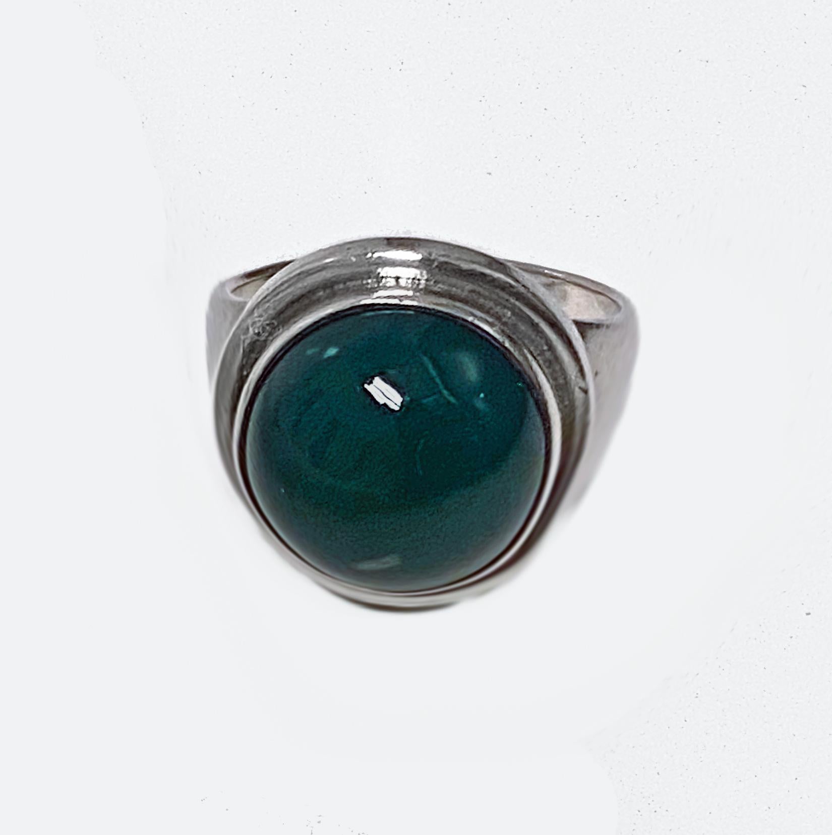 Georg Jensen very slightly oval green Chrysoprase Sterling Silver Ring C.1970. Designed by Harald Nielsen, Danish, model no. 46F. Oval cabochon chrysoprase collet set upon slightly convex outer oval frame, plain tapered shoulder. Fits very