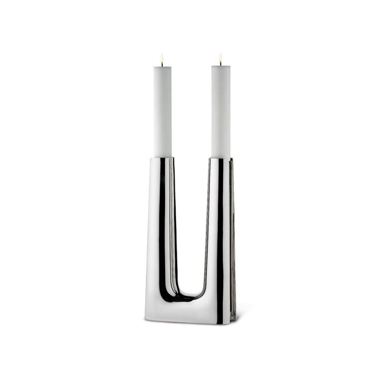 Copenhagen is a contemporary take on a Søren Georg Jensen piece first created in 1960. The candlestick was originally created in 1960 as an altar candle for use in a modern Scandinavian style church. The 2007 version is in stainless steel and holds