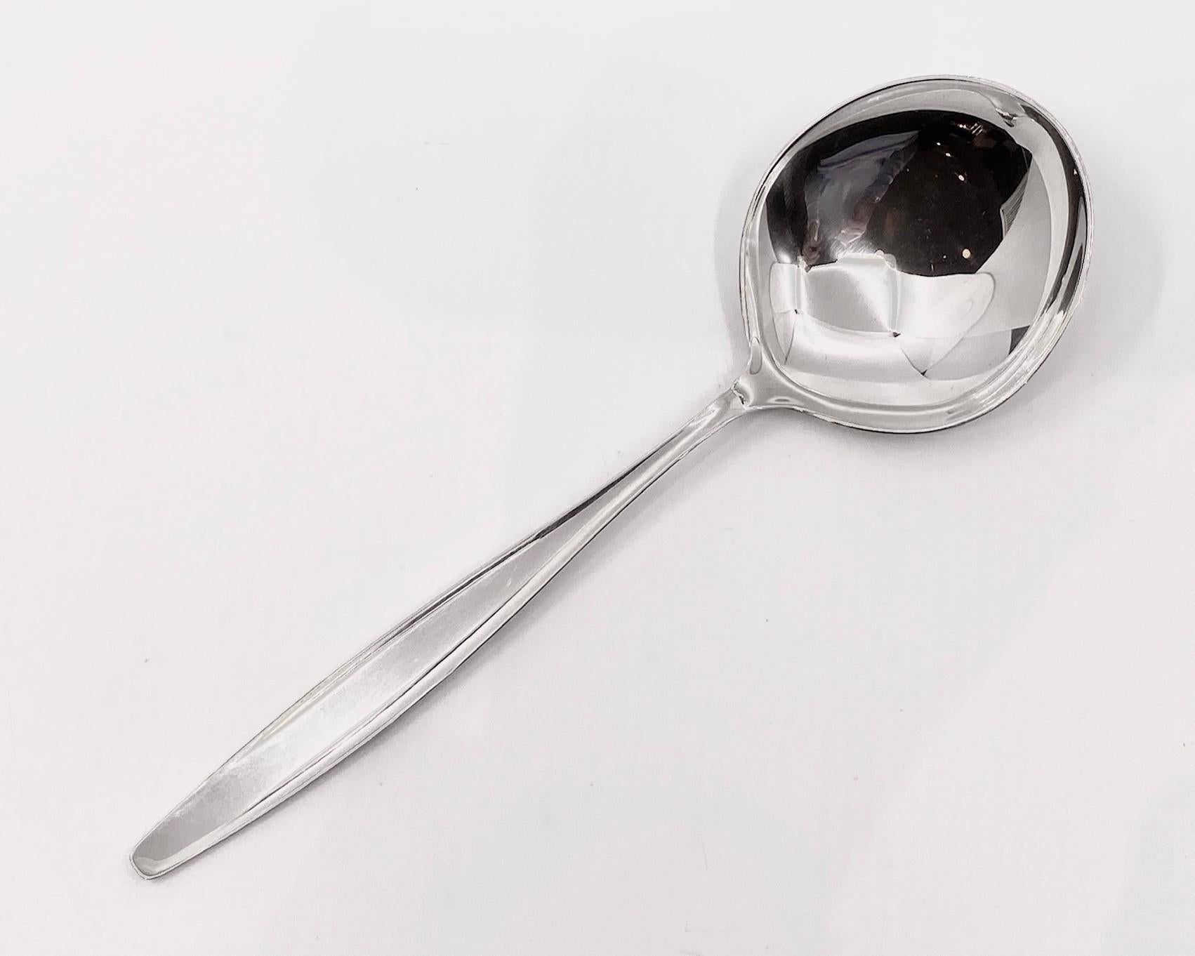 Georg Jensen sterling serving spoon, item 115 in the Cypress pattern, design #99 by Tias Eckhoff. Norwegian designer Tias Eckhoff’s Cypress was the winning design in a competition to design a flatware pattern for the 50th anniversary of the Georg