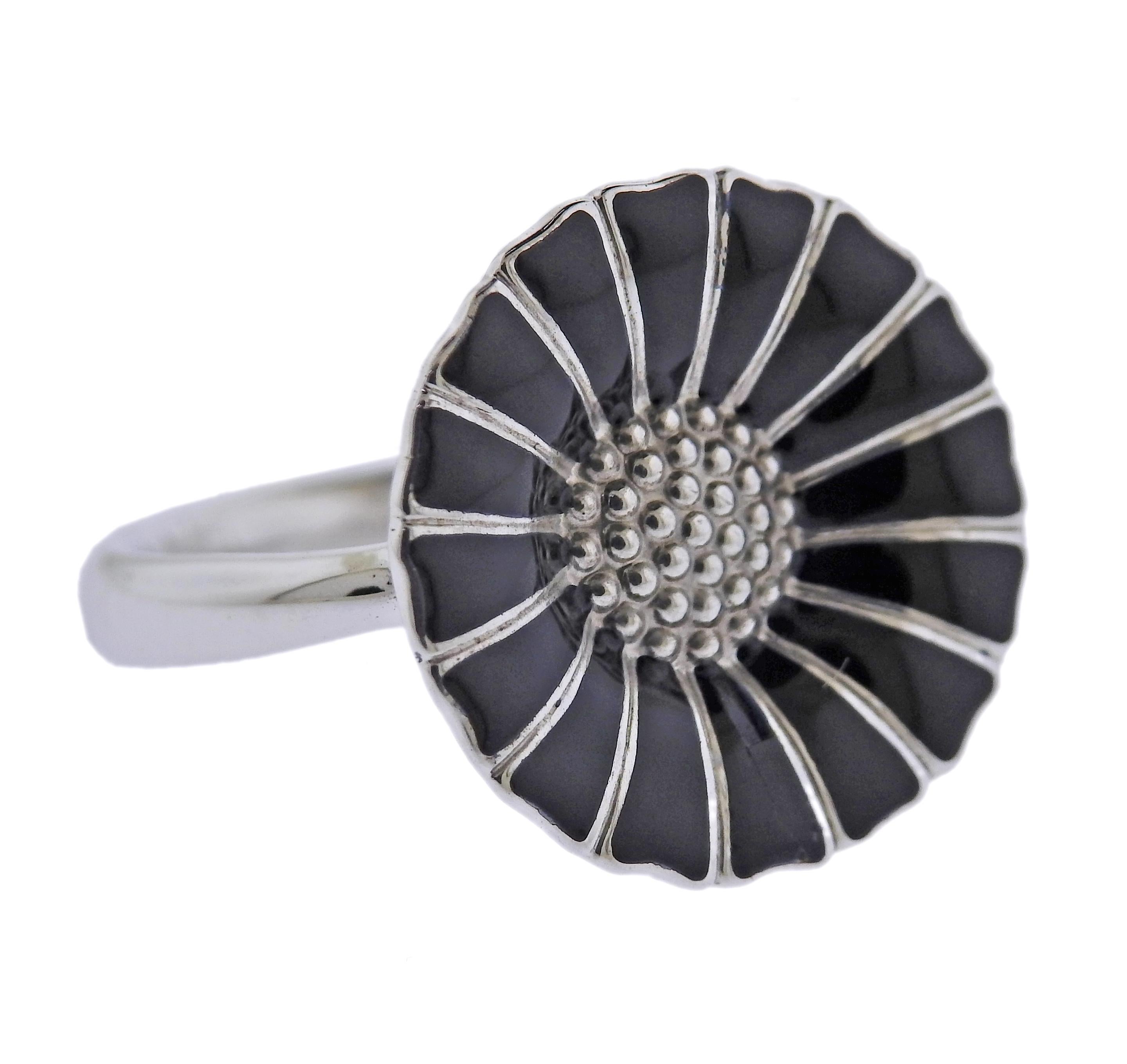 Brand new Georg Jensen sterling silver Daisy flower ring with black enamel. Ring top - 18mm. Available in sizes: 51, 56, 53. Model # 3557600. Marked: GJ mark, 925 S. Weight - 4.3 grams.