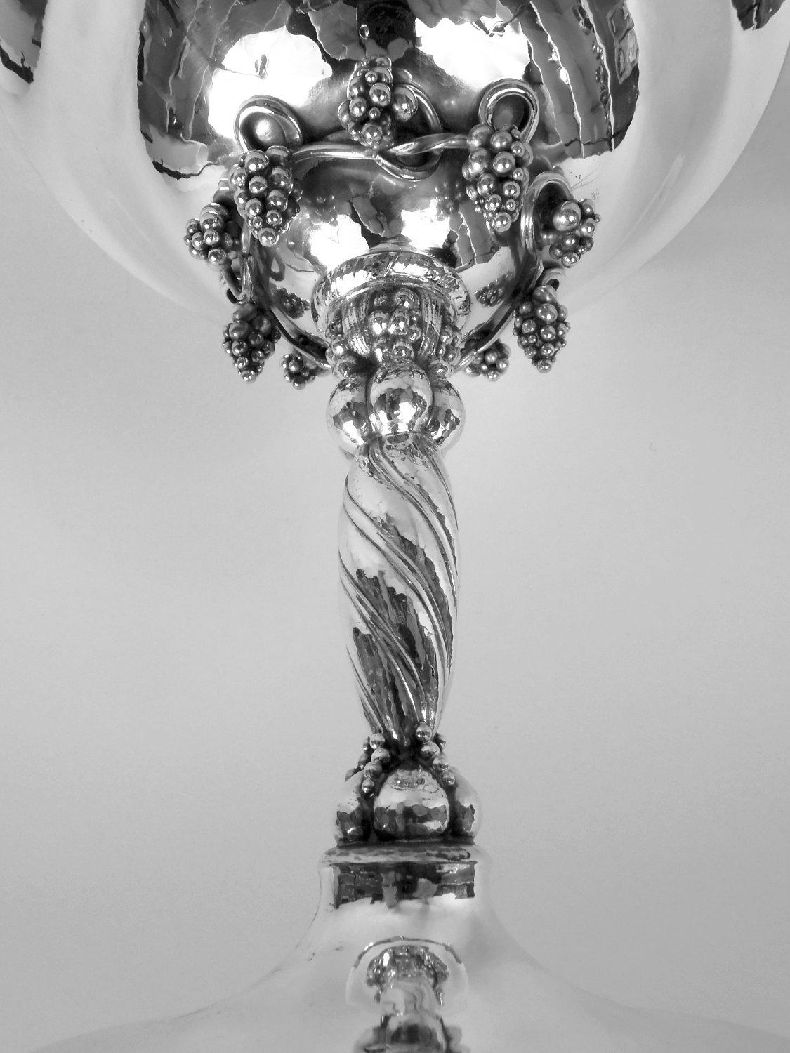 Danish Modern sterling silver compote. Made by Georg Jensen in Copenhagen. Wide and deep bowl on domed mount encircled with fruiting grapevine. Twisted and lobed shaft inset with bunches and applied beading. Visible hand hammering. A classic