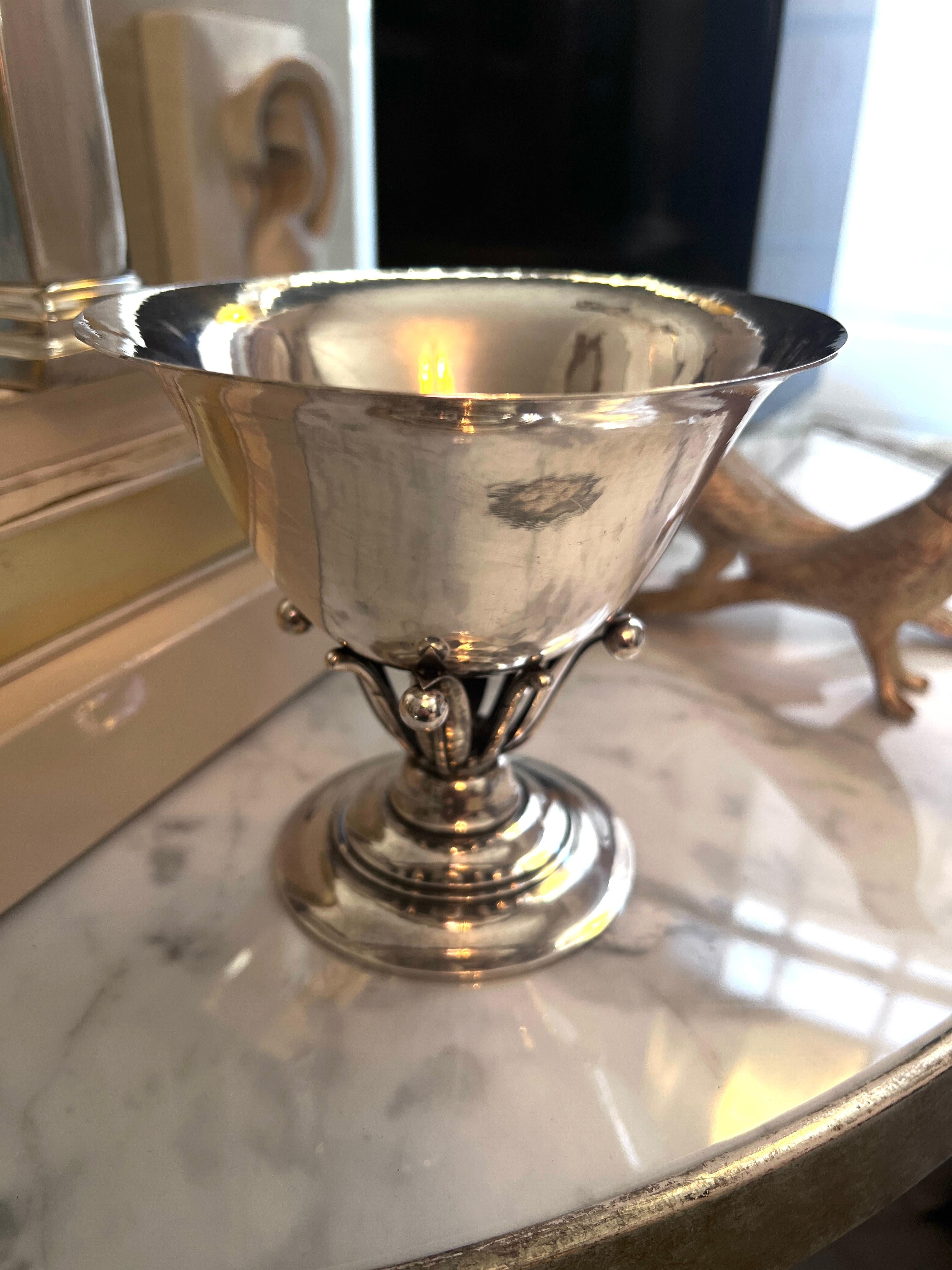 A classic Georg Jensen style bowl designed by Johan Rohde - the attention to details on the base is exquiste and quite indicative of a Jensen piece.  

A lovely addition to many places - a condiment bowl on the bar, candy dish on the cocktail table