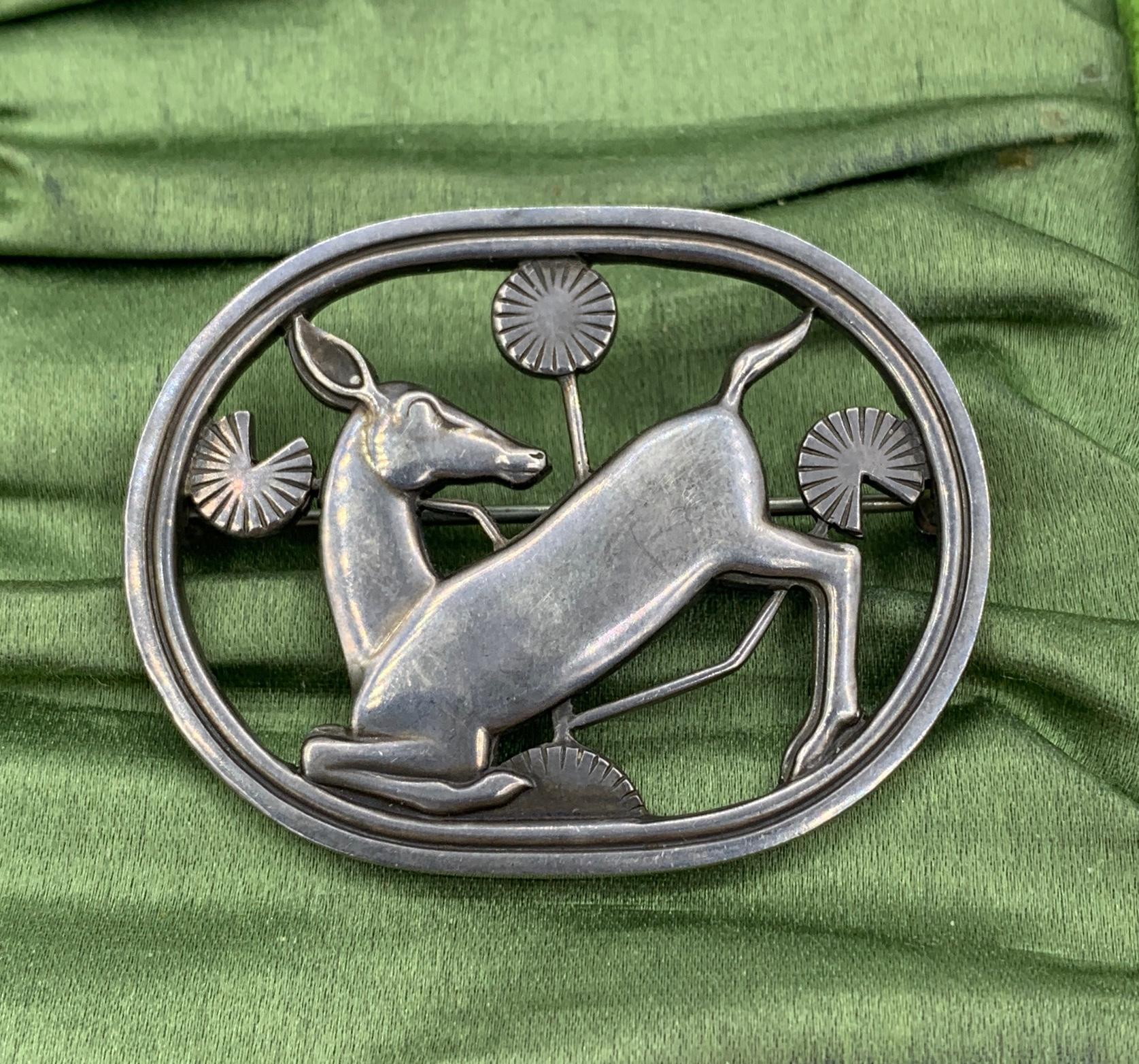 This is the wonderful Georg Jensen Denmark Sterling Silver Kneeling Deer Brooch.  The brooch is fully hallmarked with the Georg Jensen oval dotted punch, 925 Sterling Denmark and design number 256.  The classic brooch with open work design and the