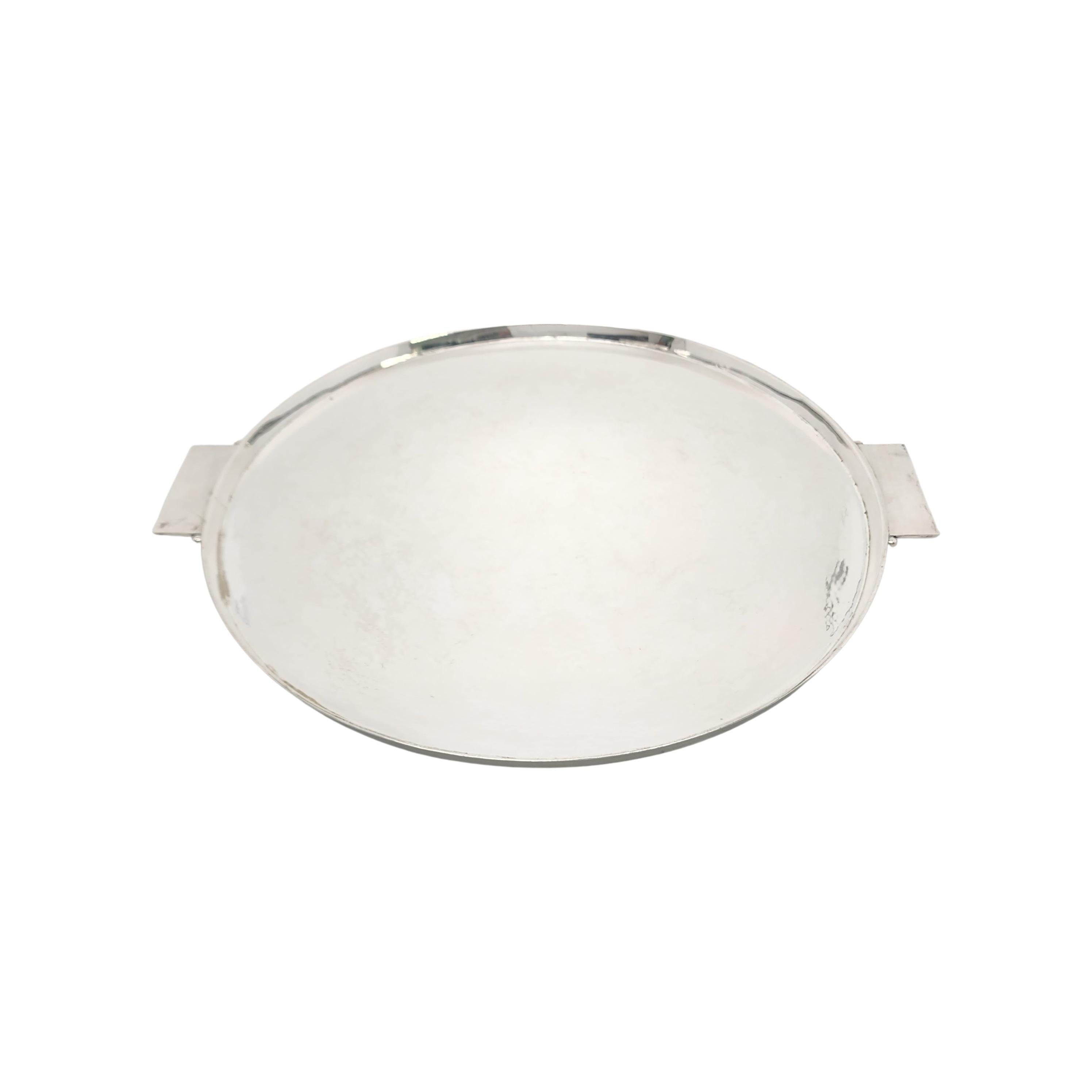 Sterling silver round tray by Georg Jensen Denmark, circa 1928.

Pattern # 529, created by long-time Jensen designer Johan Rohde, this large round tray features a lightly hammered finish, rectangular handles adorned with silver beads on each side of