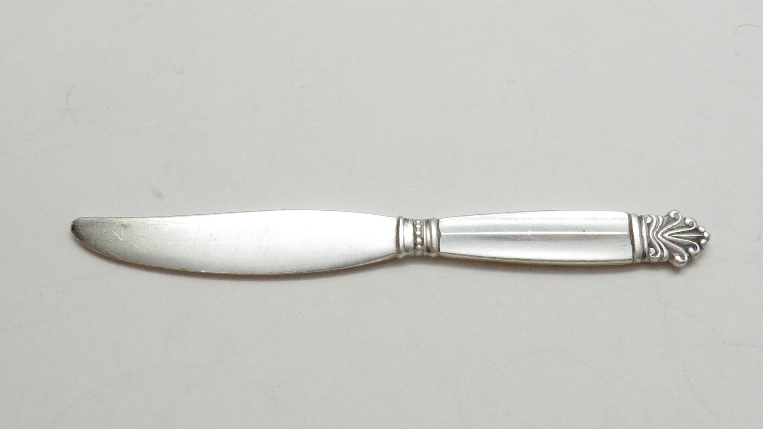 Georg Jensen sterling silver child knife/small spreader/ pate knife in the Acanthus pattern. 
Marked: STERLING DENMARK GEORG JENSEN. 
Measures 4 3/8