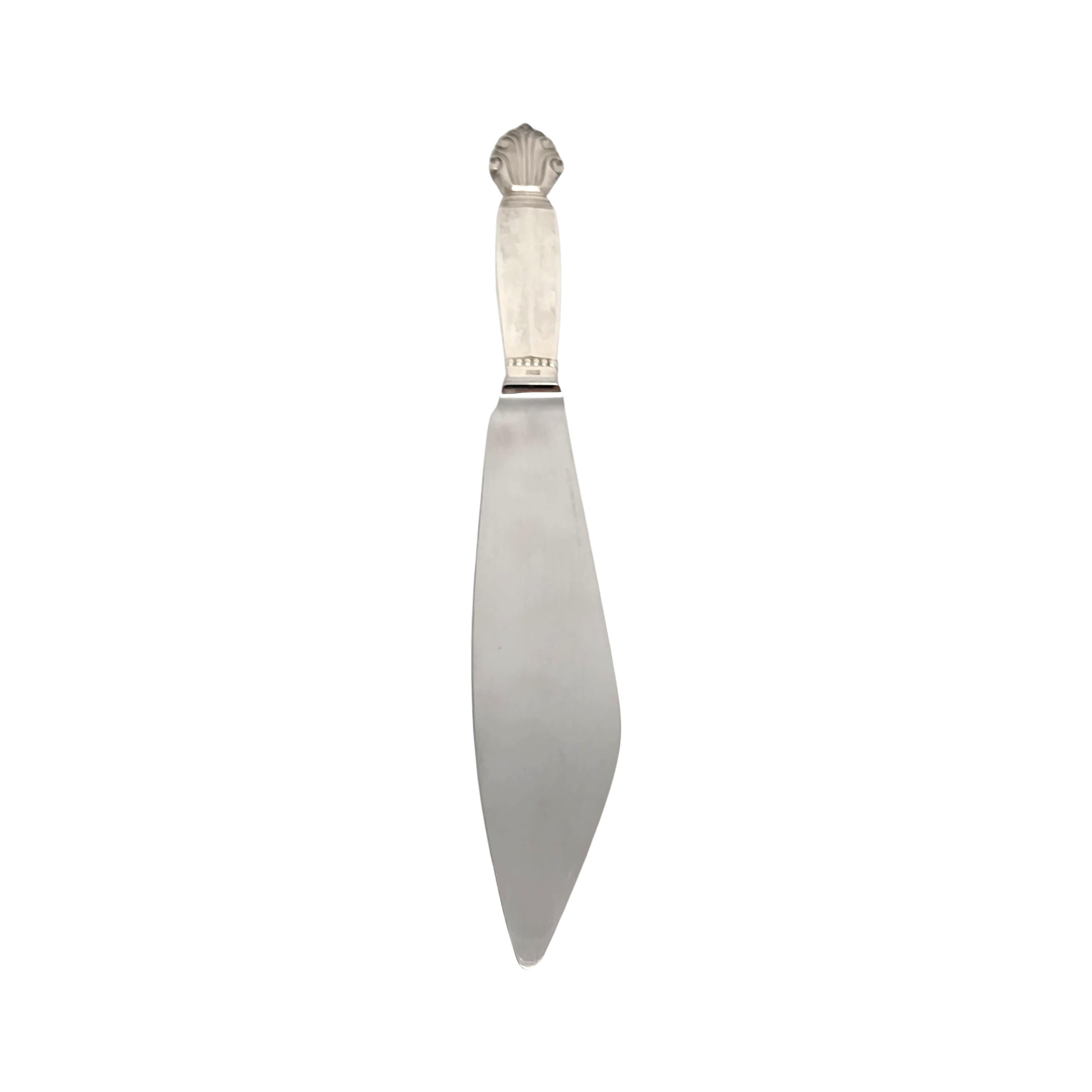 Sterling silver handle cake serving knife by Georg Jensen in the Acanthus pattern.

The Acanthus pattern was designed by Johan Rohde and introduced in 1917. The inspiration for this pattern is not of nature, but a classic motif treated in a rather