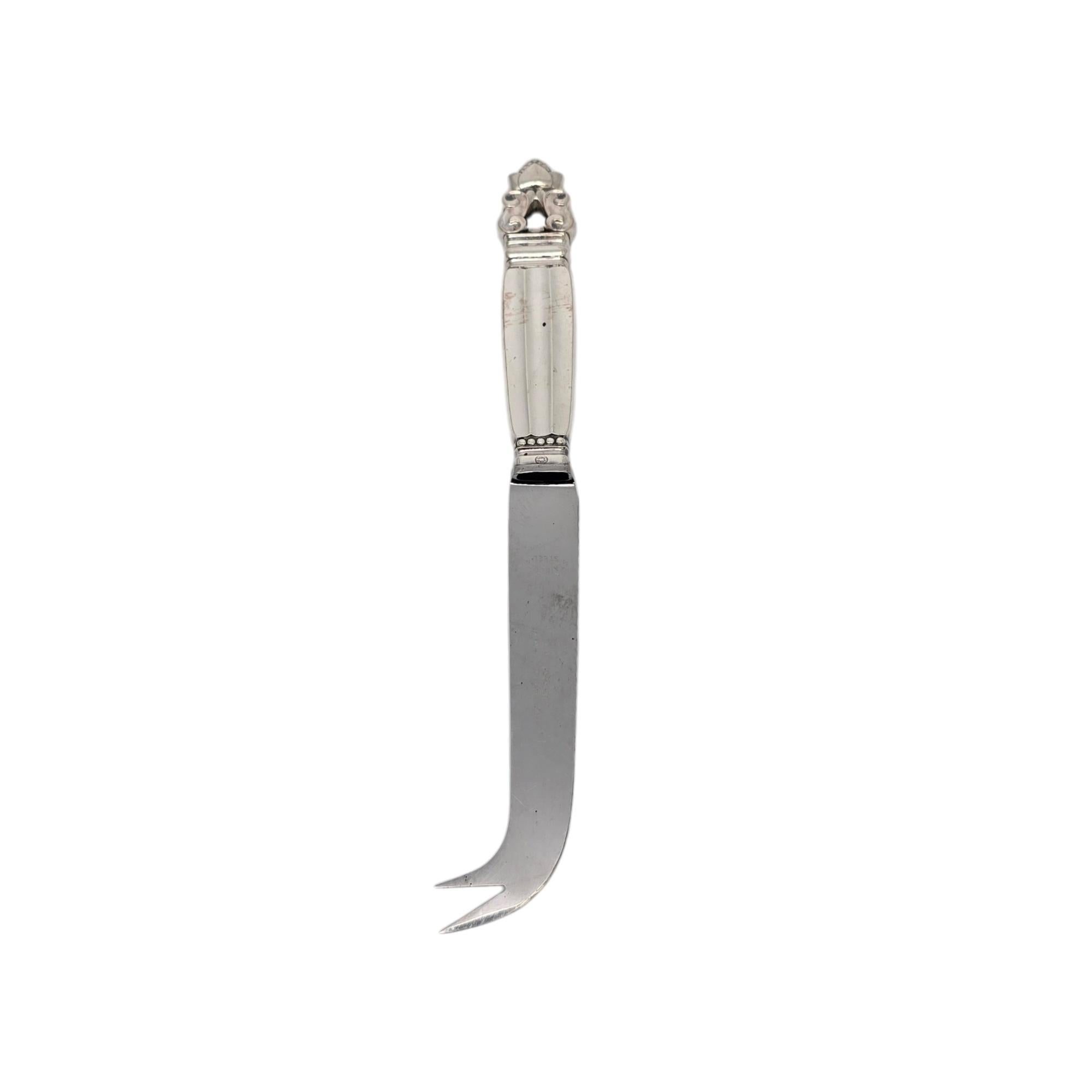 Sterling silver handle stainless blade cheese/bar knife in the Acorn pattern by Georg Jensen.

The Acorn pattern was introduced in 1915 as a collaboration between Georg Jensen and designer Johan Ronde. The Acorn pattern, which combines Art Nouveau