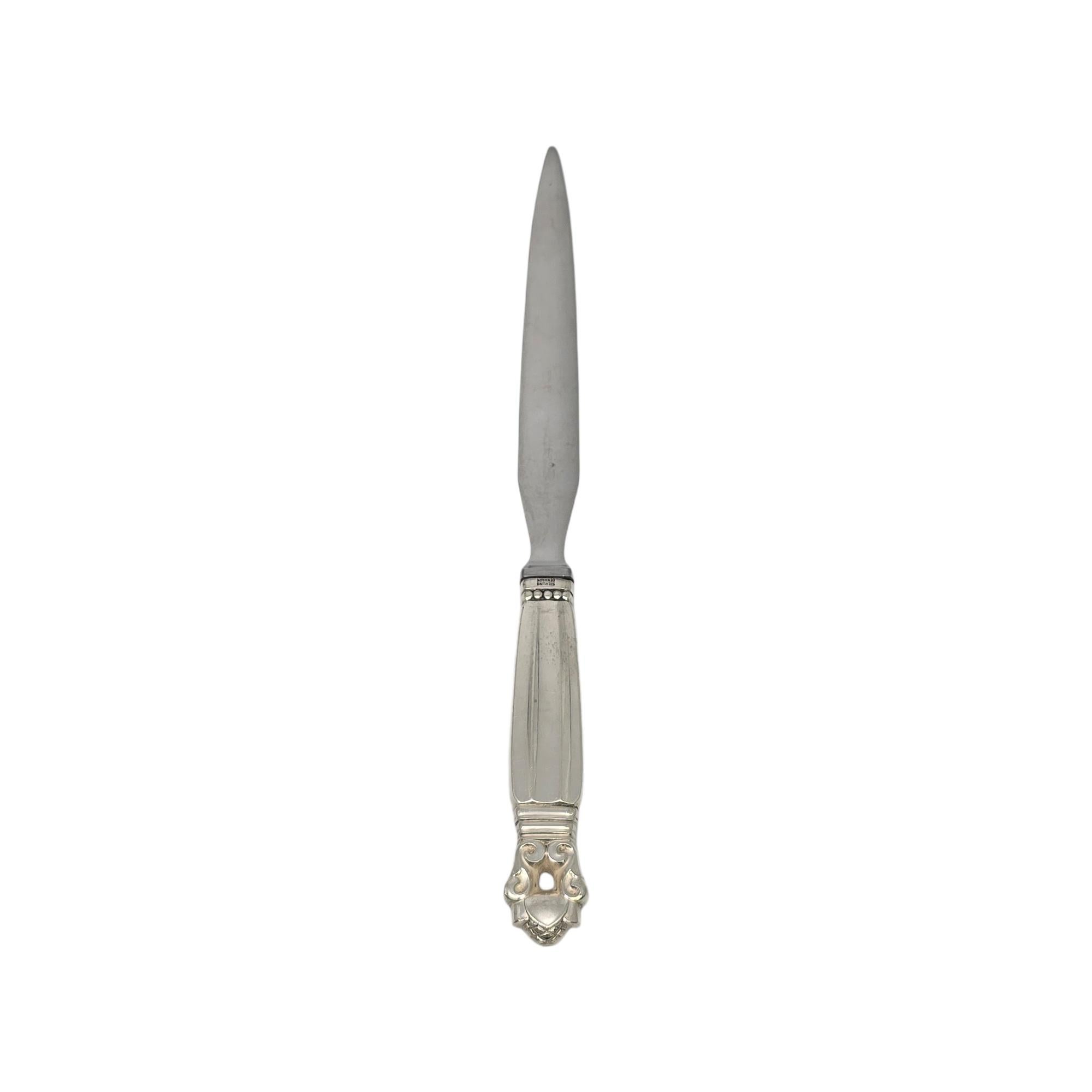 Sterling silver handle stainless blade letter opener in the Acorn pattern by Georg Jensen.

The Acorn pattern was introduced in 1915 as a collaboration between Georg Jensen and designer Johan Ronde. The Acorn pattern, which combines Art Nouveau and