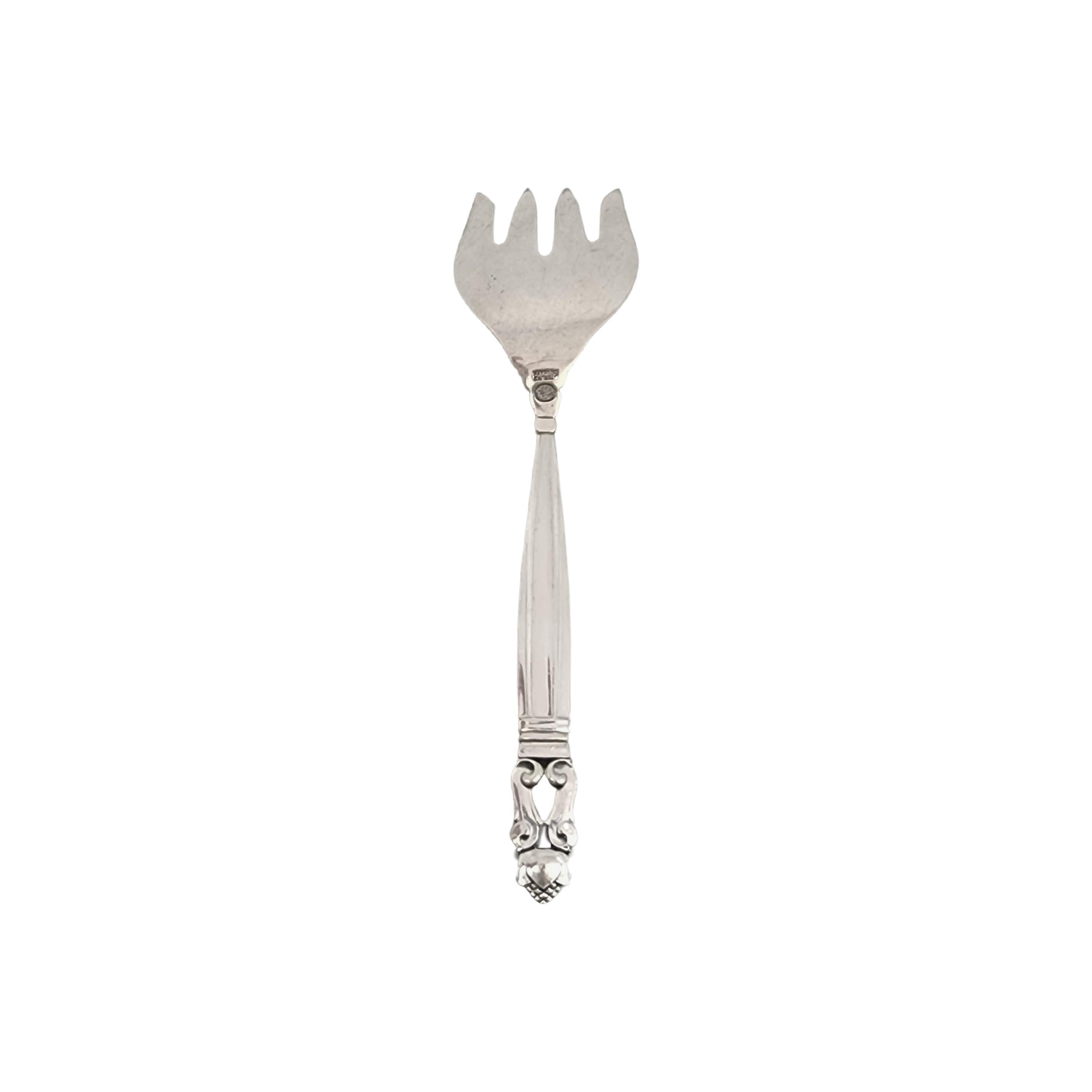 Vintage Georg Jensen Denmark sterling silver sardine serving fork in the Acorn pattern.

 No monogram.

The Acorn pattern was introduced in 1915 as a collaboration between Georg Jensen and designer Johan Ronde. The pattern, which combines Art