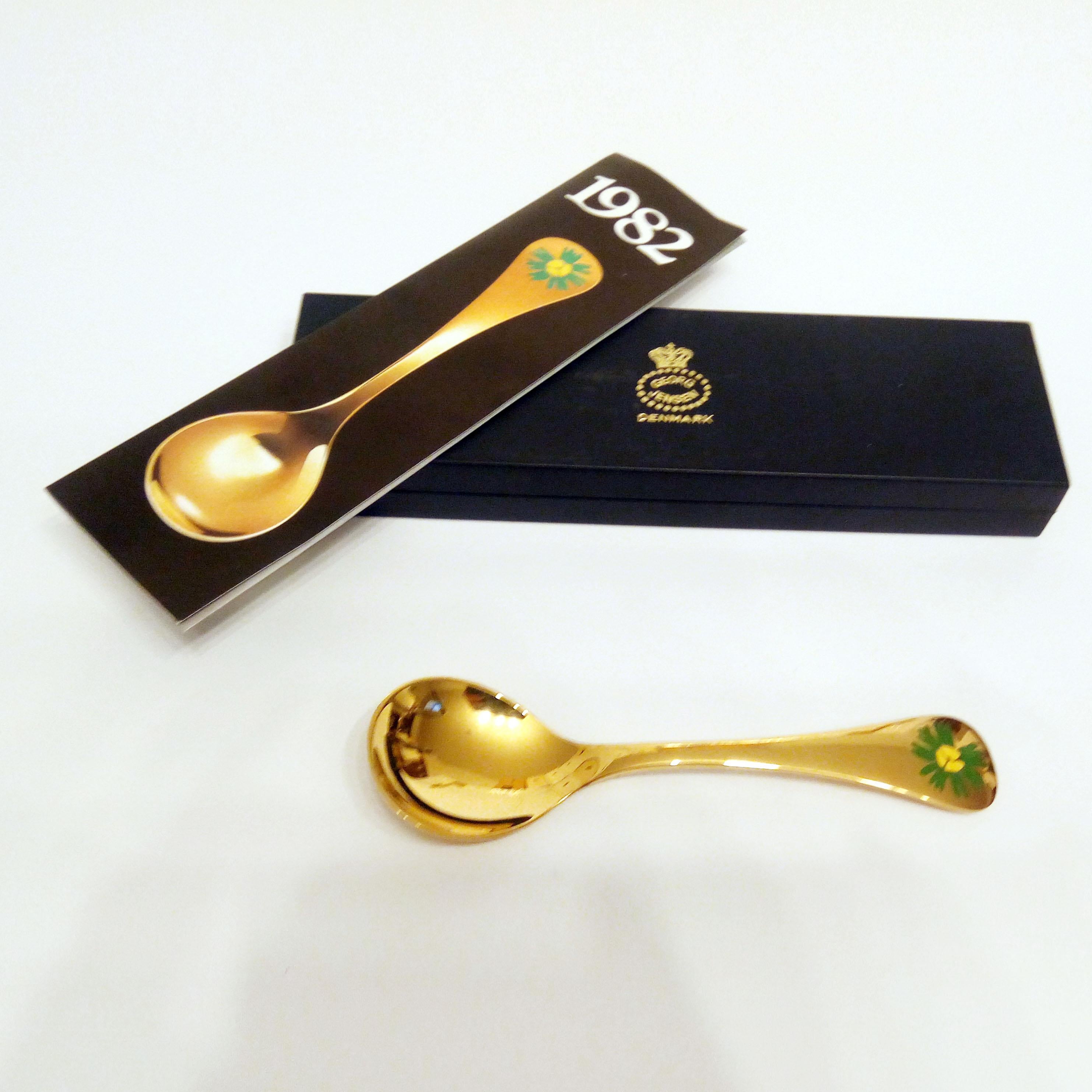 Annual spoon 1982 in original box, designed by Annelise Björner, edited by Georg Jensen.
Annual spoons series began in 1971. Each spoon is crafted in sterling silver, then gold-plated and enameled with a wildflower chosen for that year. The 1982