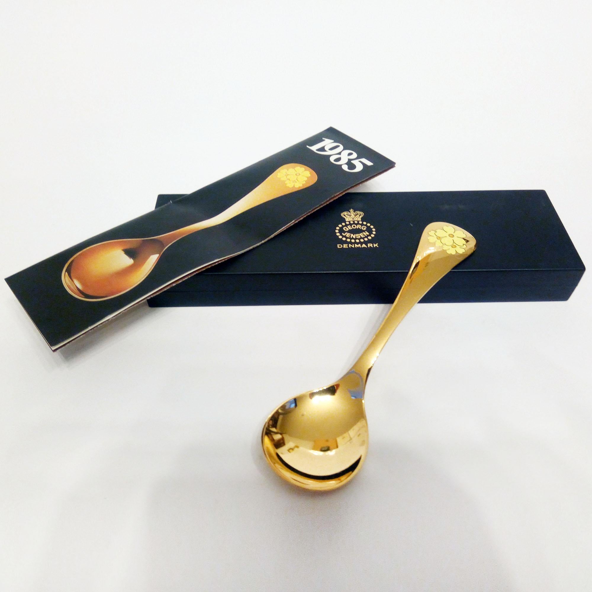 Annual spoon 1985 in original box, designed by Annelise Björner, edited by Georg Jensen.
Annual spoons series began in 1971. Each spoon is crafted in sterling silver, then gold plated and enameled with a wildflower chosen for that year. The 1985