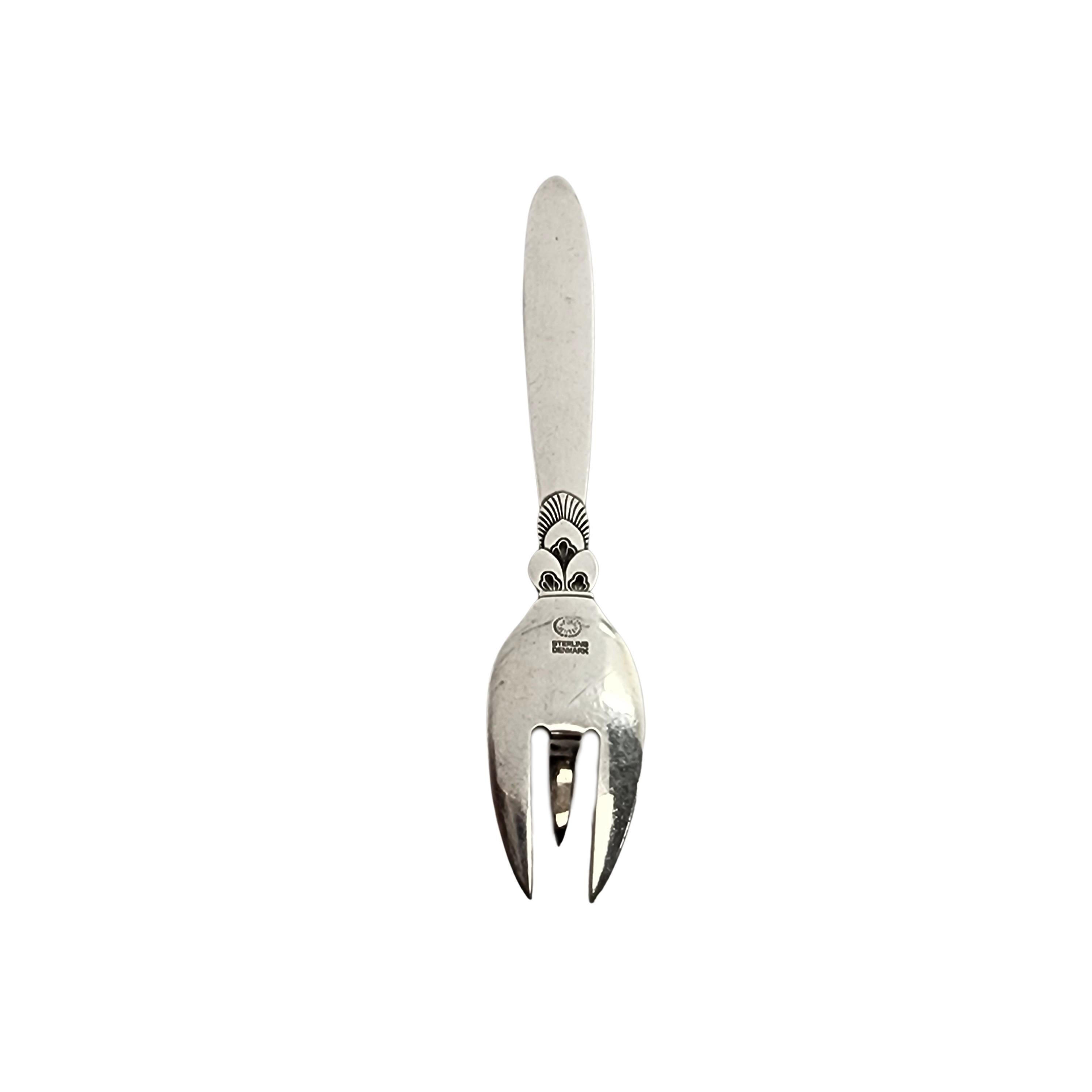 Sterling silver lemon fork by Georg Jensen Denmark in the Cactus pattern.

Created by long-time Jensen designer Gunorph Albertus, the Cactus pattern was introduced in 1930 and features a character-rich Art Deco design. This small fork features a