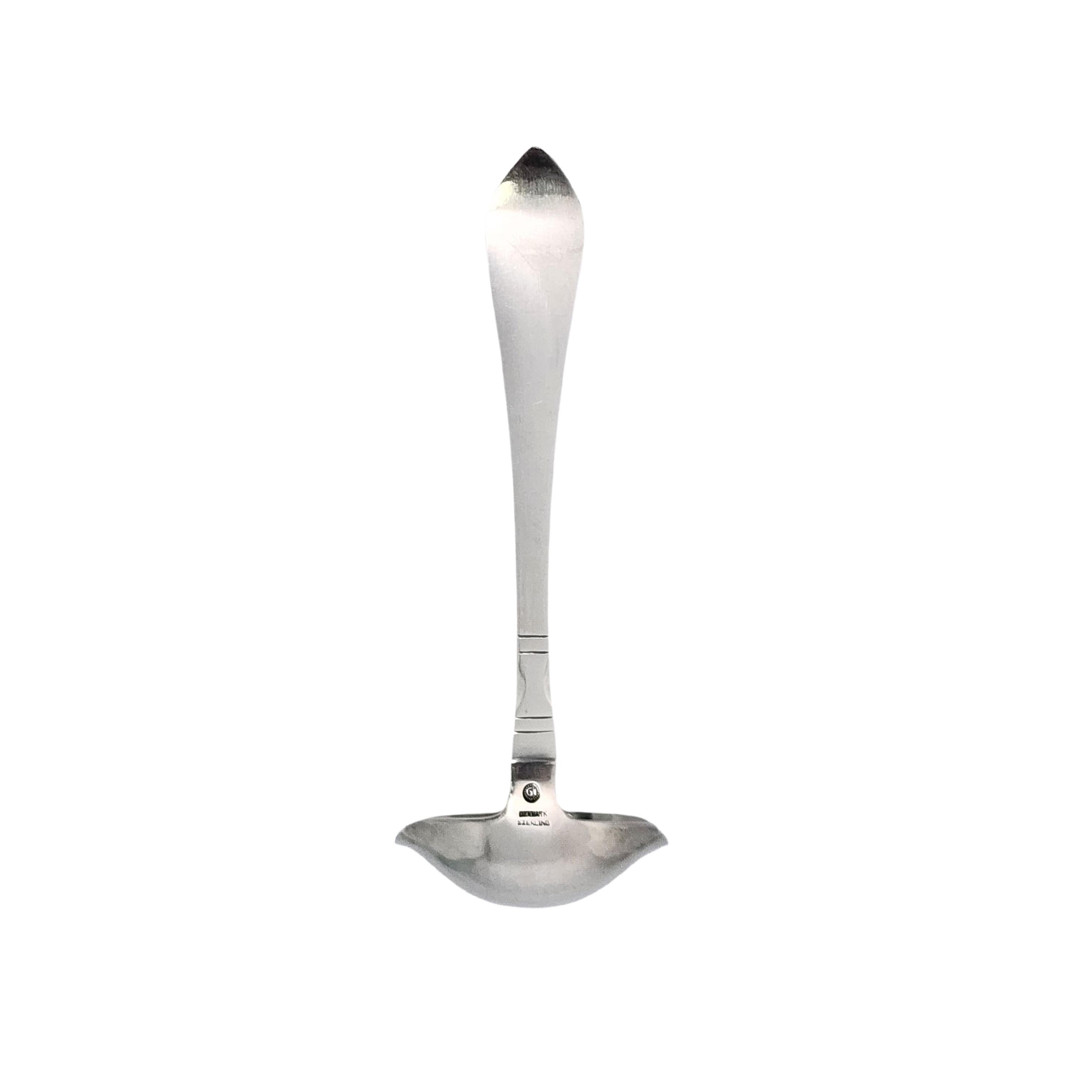 Vintage Georg Jensen Denmark sterling silver cream ladle in the Continental pattern.

 No monogram.

The Continental pattern was designed in 1906 as the first major cutlery line from Georg Jensen. The pattern was inspired by traditional Nordic
