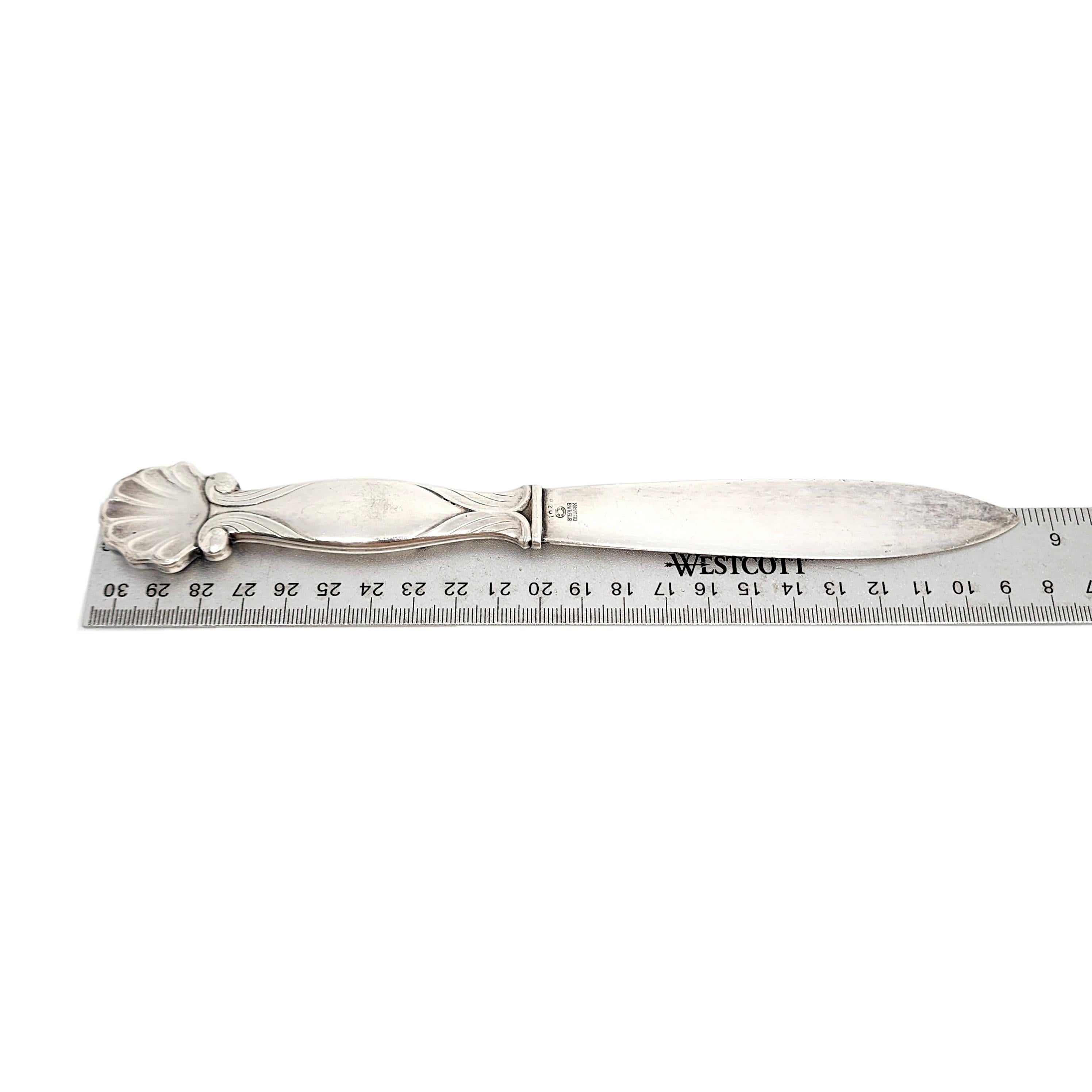 Vintage sterling silver letter opener by Georg Jensen in the Ornamental Shell #102 pattern, circa 1930s.

No monogram

Shell design a top the handle with scroll accents. The hallmark dates the piece circa 1930s.

Measures approx 9