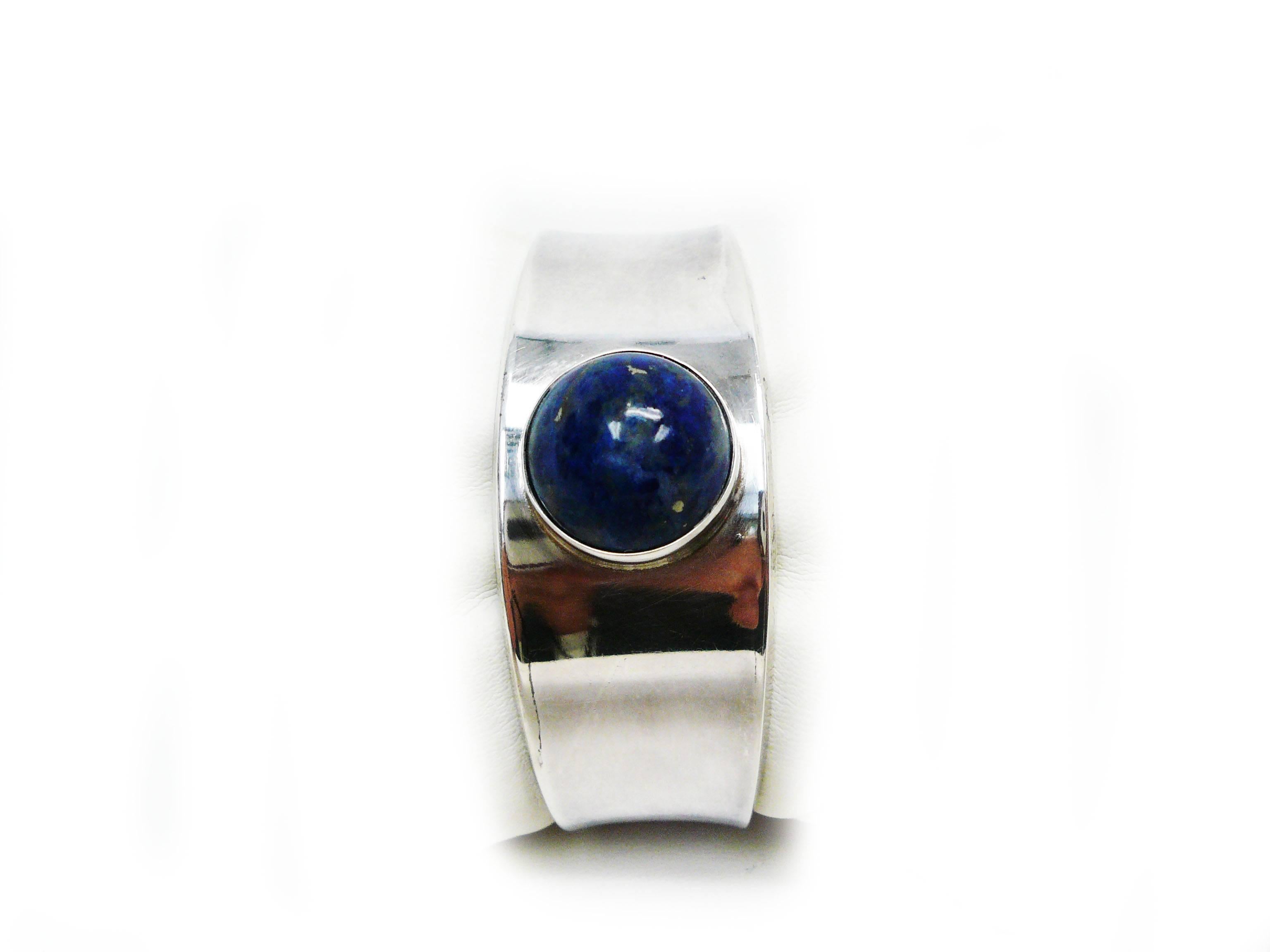 Post WWII design by Paul Hansen for Georg Jensen.
Classic sterling silver slightly tapered cuff bracelet with 16 mm round lapis
lazuli gemstone bezel-set.
Many fine artists worked for the Georg Jensen company through the company history.
This beauty