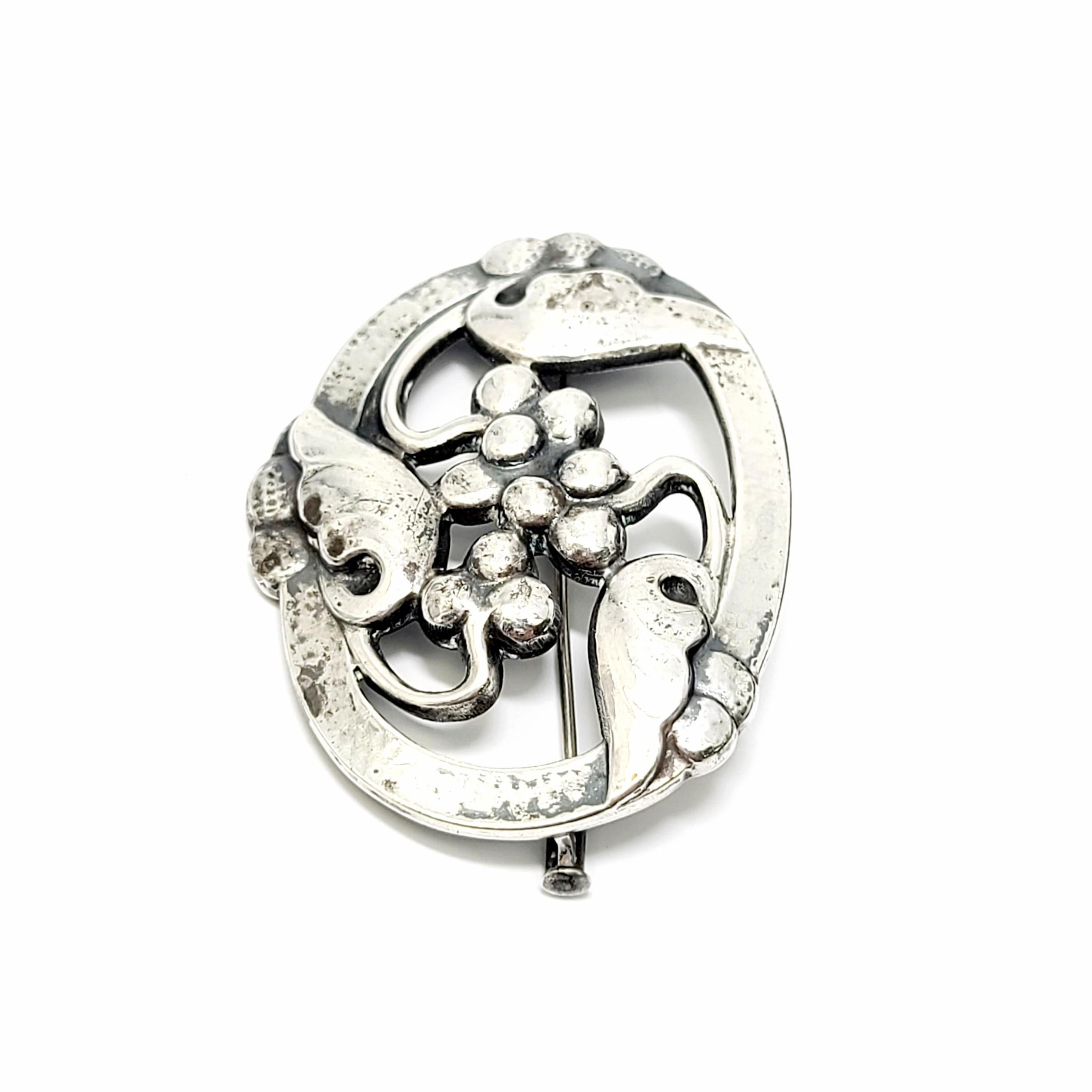 Sterling silver Moonlight & Grapes pin by Georg Jensen, Denmark.

Pattern # 101, featuring leaves and grapes is a classic Jensen nature motif.

Measures approx 1 3/8