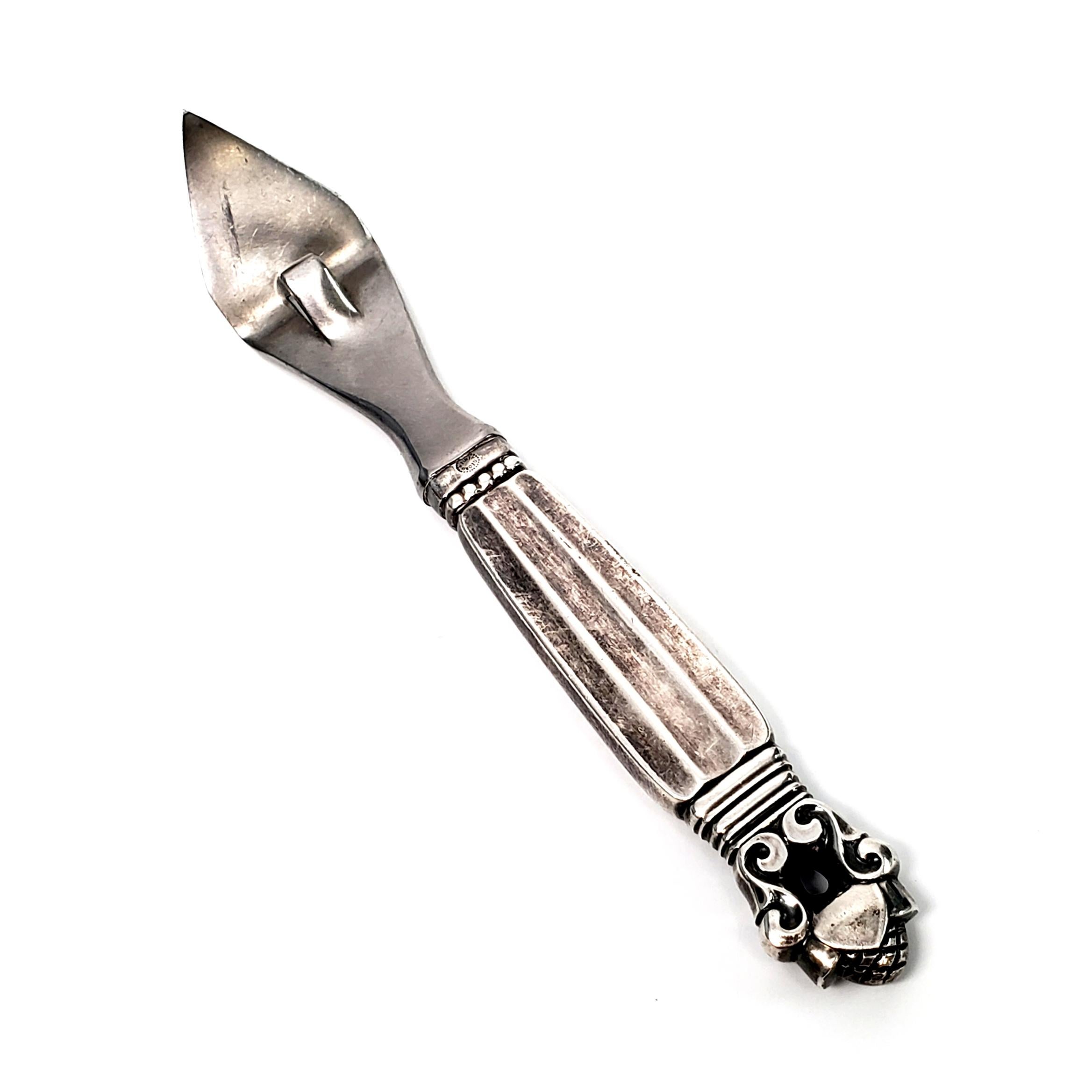 Sterling silver handle can opener with stainless implement from Georg Jensen in the Acorn pattern.

The Acorn pattern was introduced in 1915 as a collaboration between Georg Jensen and designer Johan Ronde. The Acorn pattern, which combines Art