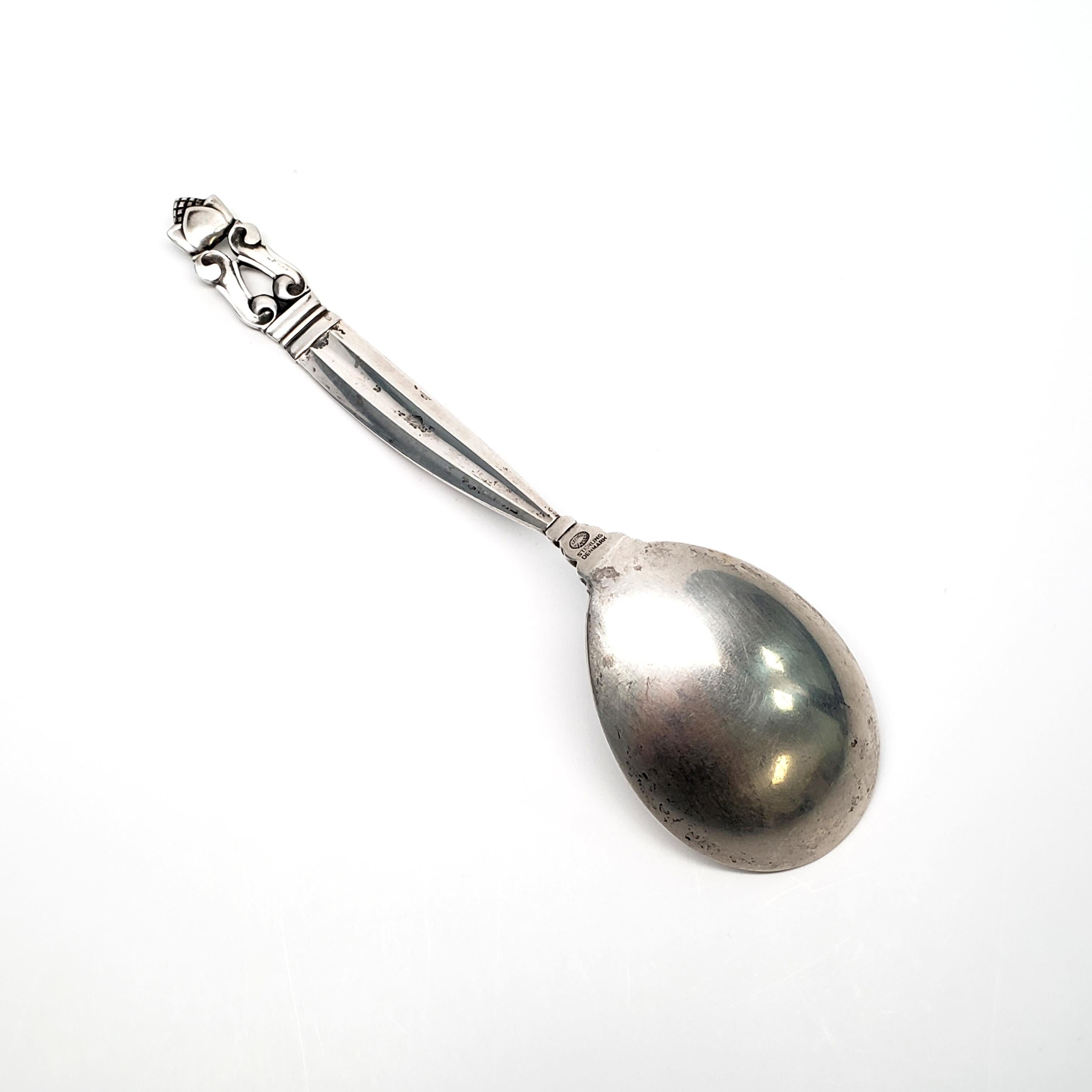 Vintage sterling silver curved handle jam spoon from Georg Jensen in the Acorn pattern. The Acorn pattern was introduced in 1915 as a collaboration between Georg Jensen and designer Johan Ronde. The pattern combines Art Nouveau and Art Deco styles,