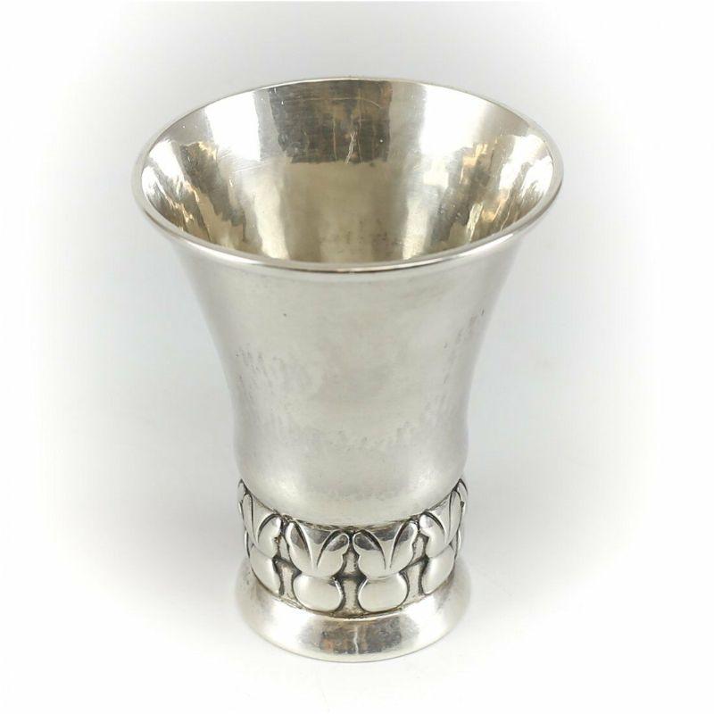 Georg Jensen Denmark sterling silver flared cup, circa 1919.

A rare circa 1919 Georg Jensen Danish sterling silver flared cup. Lightly hand hammered with hand chased leaf designs towards the base stem. #102. Made in Denmark.

Additional