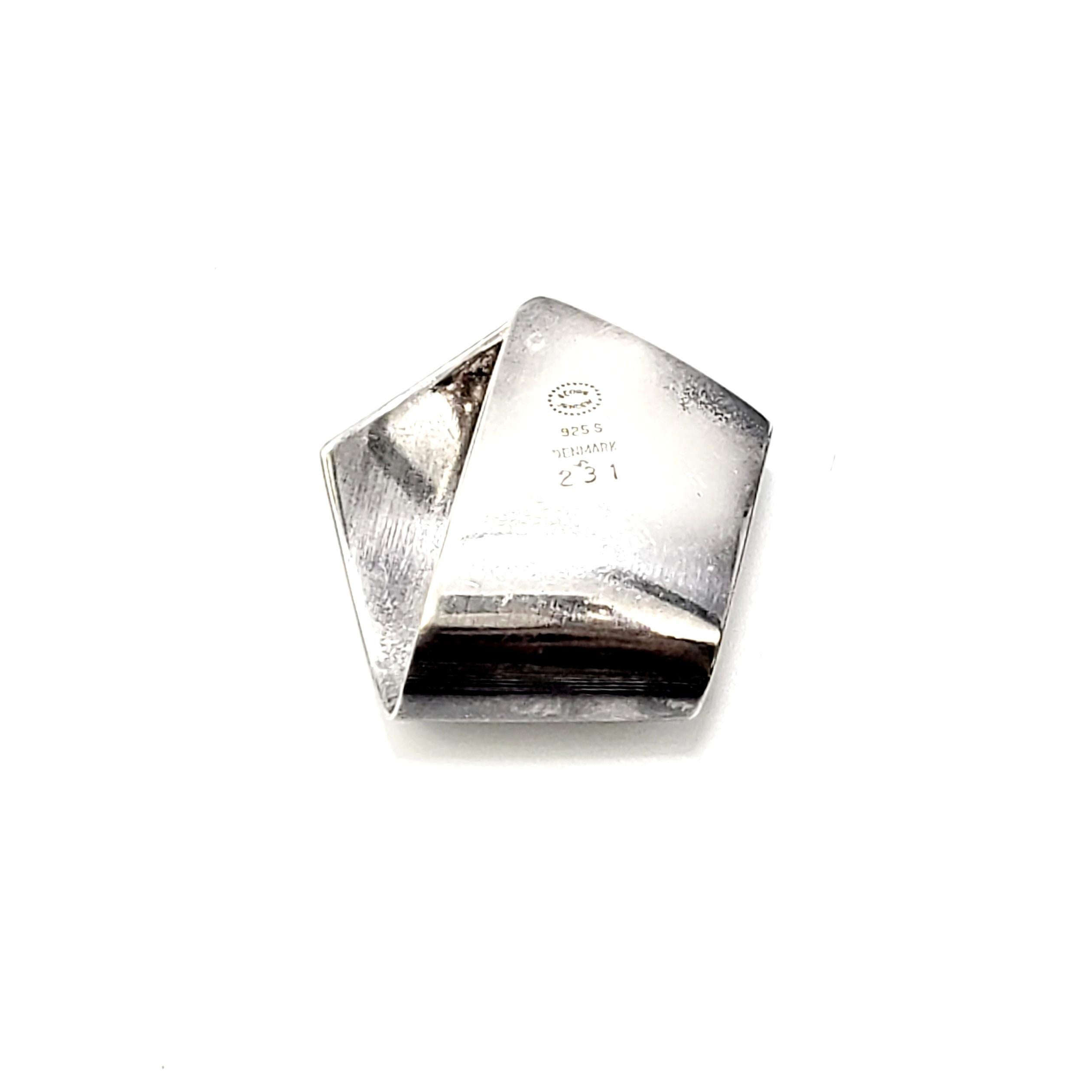 Georg Jensen sterling silver pendant, pattern #231.

This modernist piece features a folded design.

Measures 1 1/8