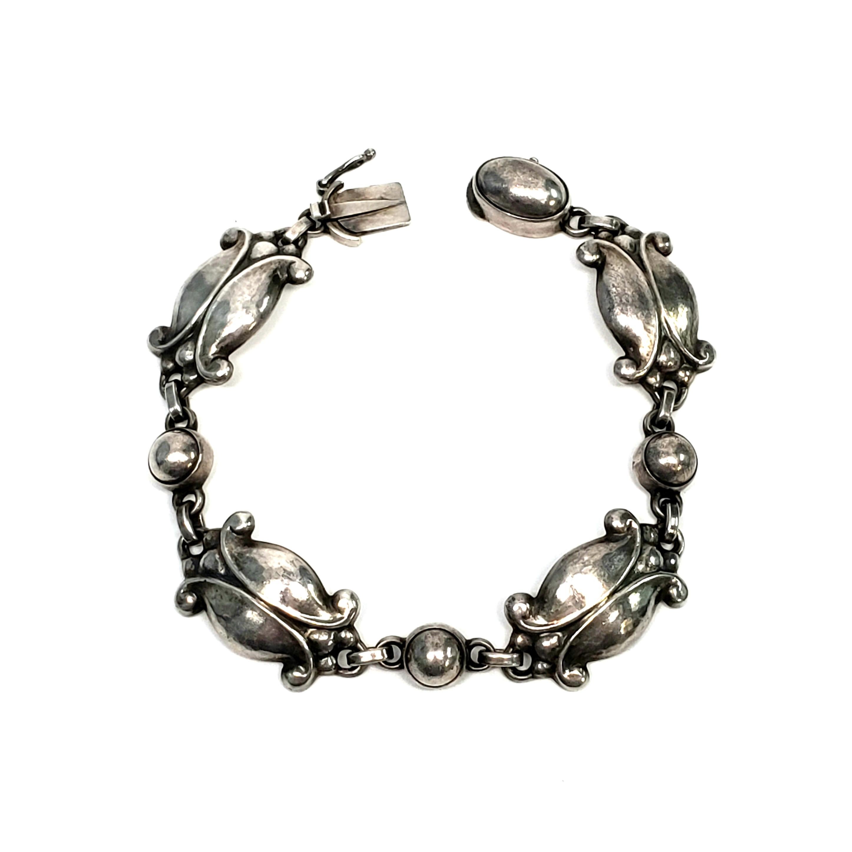 Vintage Georg Jensen sterling silver bracelet in the Moonlight Blossom pattern, #11, circa 1945.

The Moonlight Blossom pattern was designed by Georg Jensen himself, inspired by nature motifs, as is typical of Georg Jensen's work. This beautiful