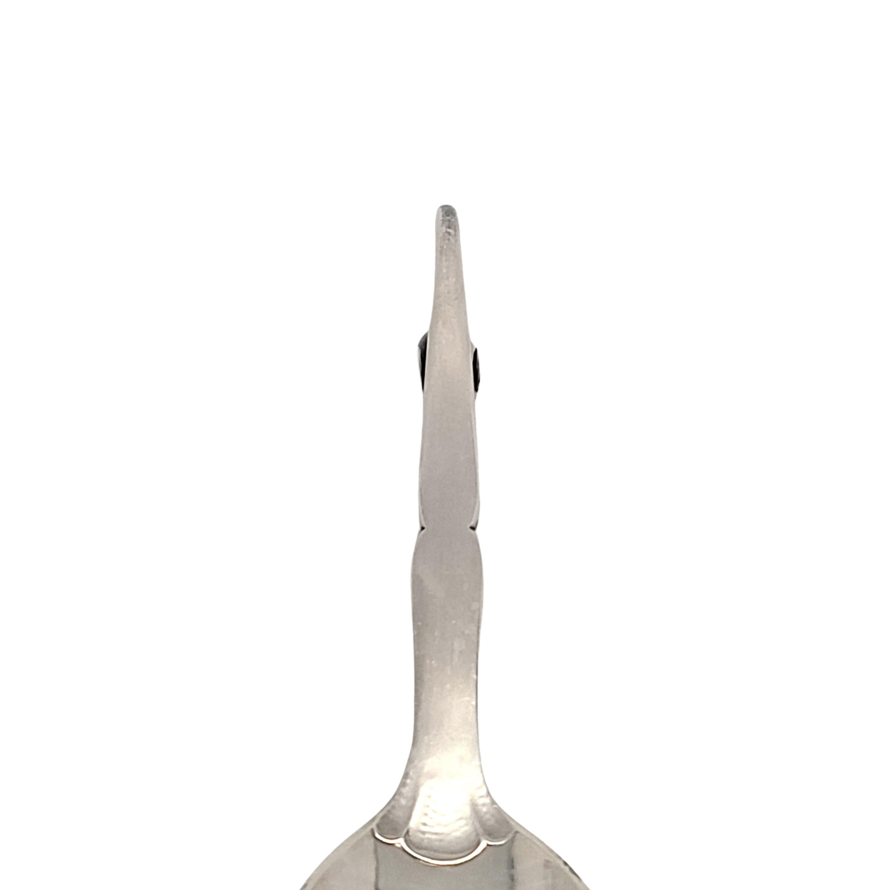 Georg Jensen Denmark sterling silver jam/condiment spoon in the Ornamental #21 pattern.

No monogram

This beautiful spoons features a lightly hammered pierced bowl, with a beautifully ornate curved handle featuring a peapod leaf with small silver