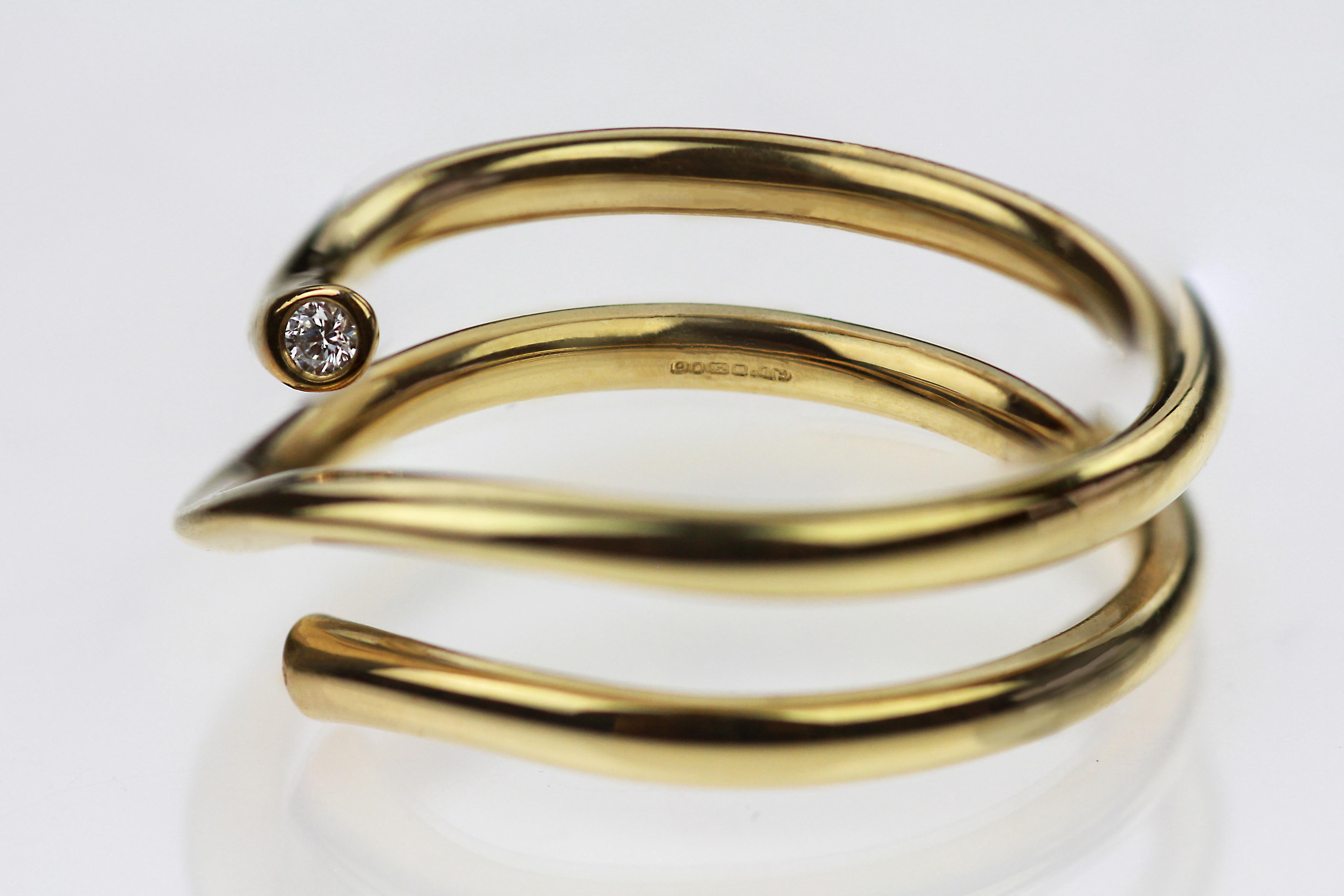 Could be wear with together with eternity ring. 
Sophisticated, this ring is a gorgeous piece waiting to be worn. The ring itself is a loosely coiled gold stream, resembling the slither of a snake or the joyous streamers floating in the air at
