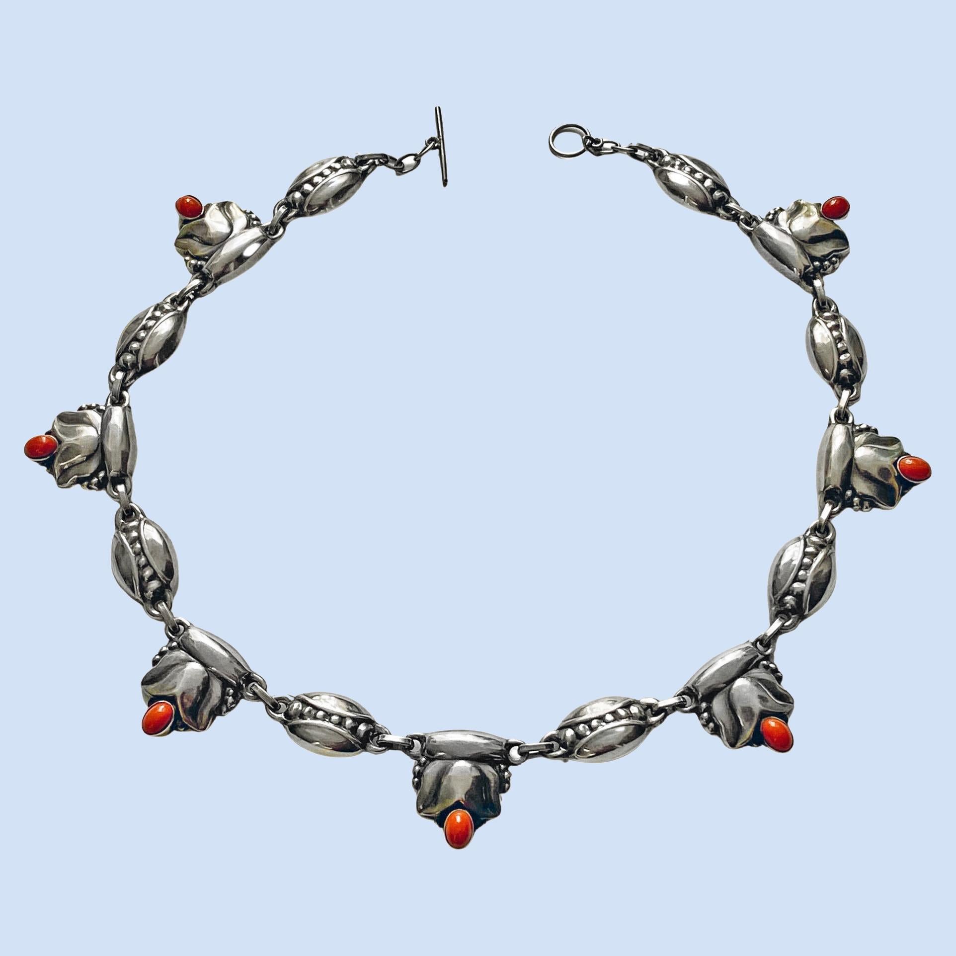 Georg Jensen rare design Sterling Silver and coral color Necklace C.1930, design No. 3. The Necklace composed of leaf and bud motifs. Length: 18.125 inches. Item Weight: 44.94 grams. Marks for Georg Jensen, GJ, 925 Sterling Denmark, 3. Similar