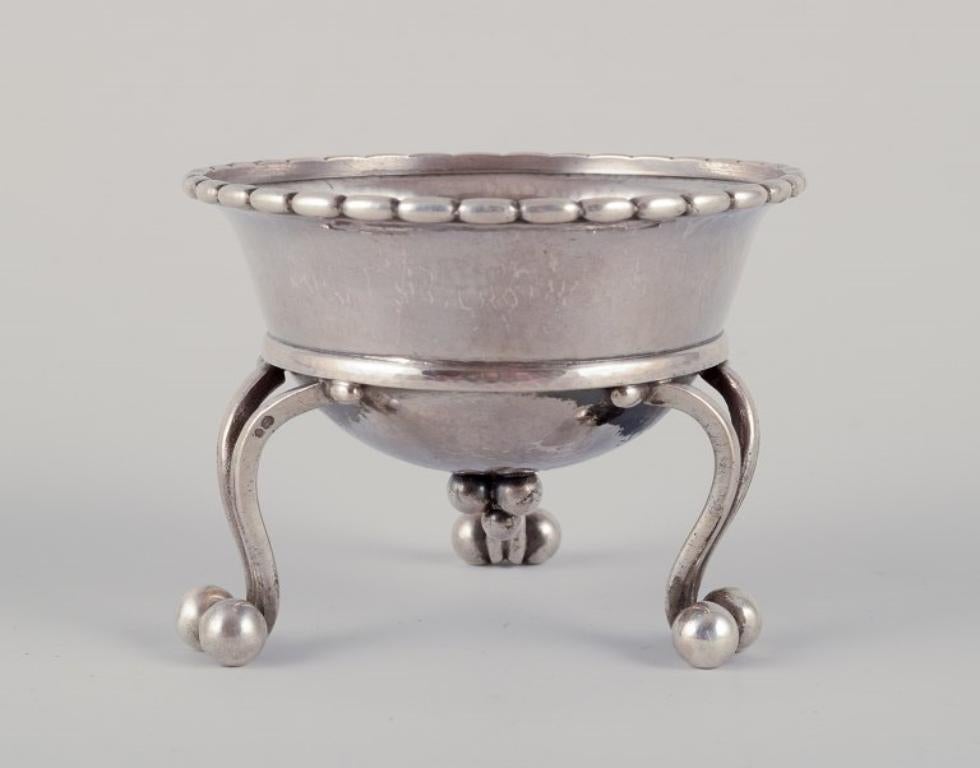 Danish Georg Jensen, early tea strainer with holder in 830 silver.