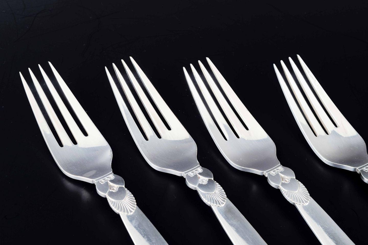 PRE-OWNED GOODS ARE EXEMPT FROM IMPORT TARIFFS FOR U.S., UK, AUSTRALIAN & CANADIAN CUSTOMERS.   
THEREFORE, NO IMPORT TARIFFS WILL BE APPLICABLE TO YOUR PURCHASE. 

Georg Jensen. Four large dinner forks in the “Cactus” pattern.
Sterling