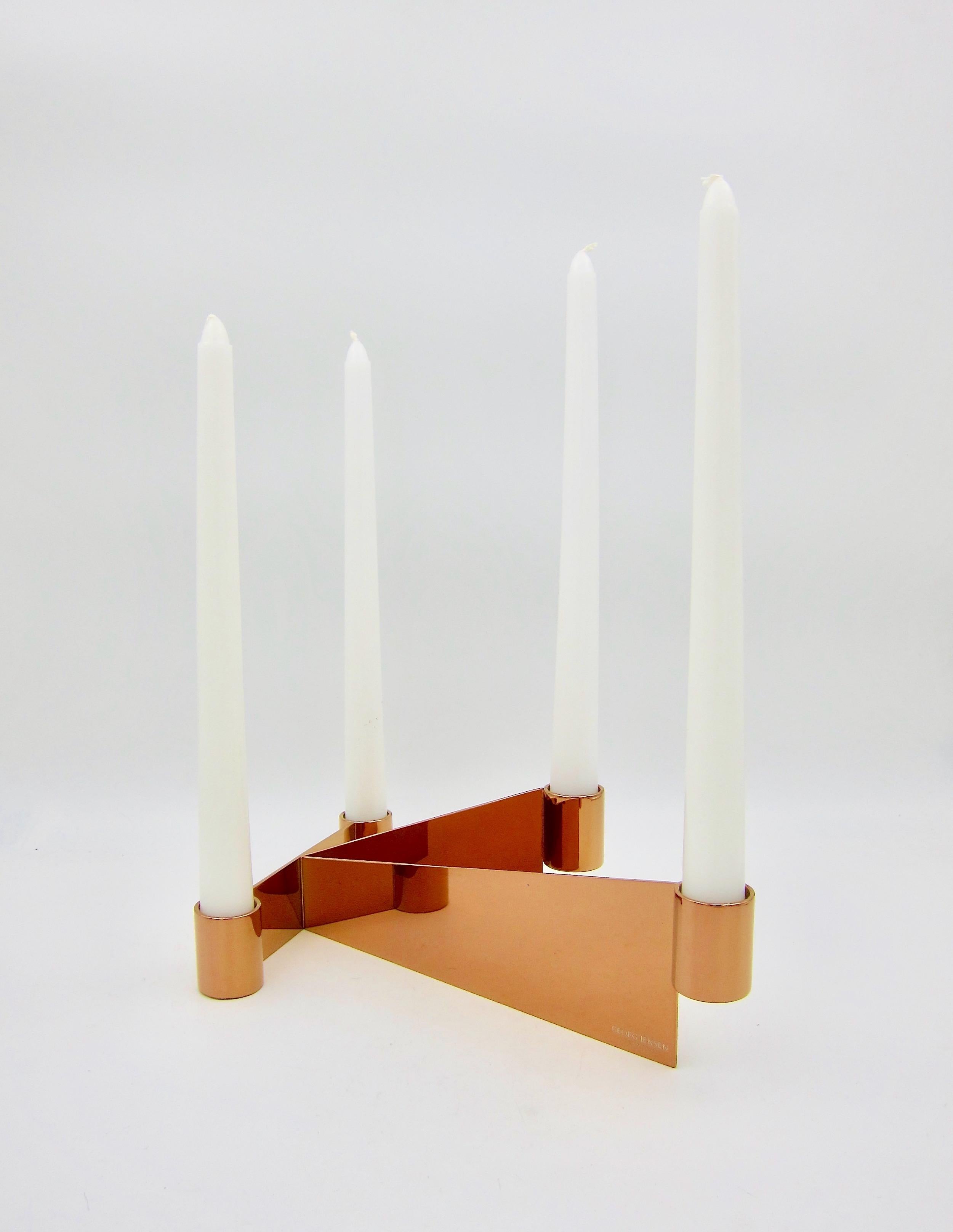 A pair of Georg Jensen four-light candle holders in stainless steel with a warm and reflective copper-colored and scratch-resistant PVD coating. The sleek and minimal Urkiola Collection was a successful 2016 collaboration between Spanish-born