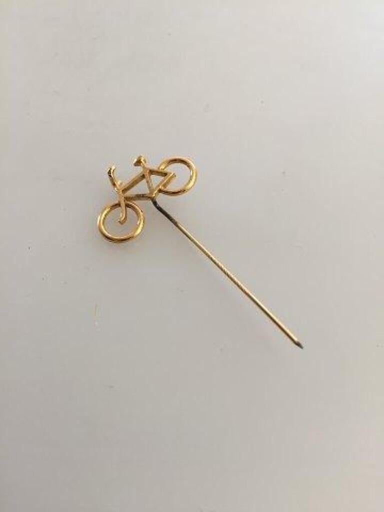 Georg Jensen Gilded Brass Bicycle Pin needle. 
Designed by Ole Bent Petersen
Measures 5.8cm / 2 9/32in. x 2.7cm / 1 1/16in.
Weighs 1.8g / 0.06oz.